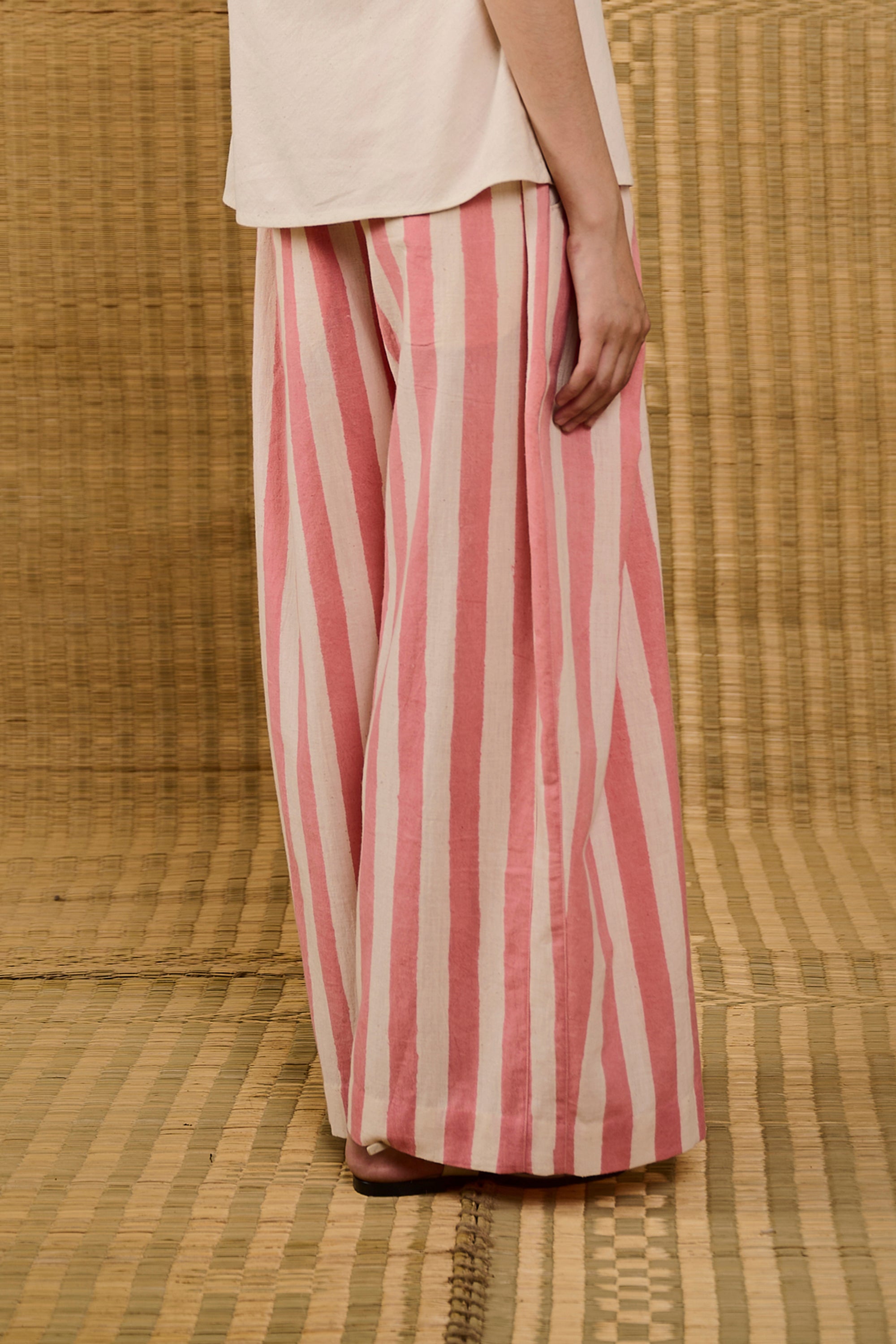 A side shot of woman wearing pink wood pant