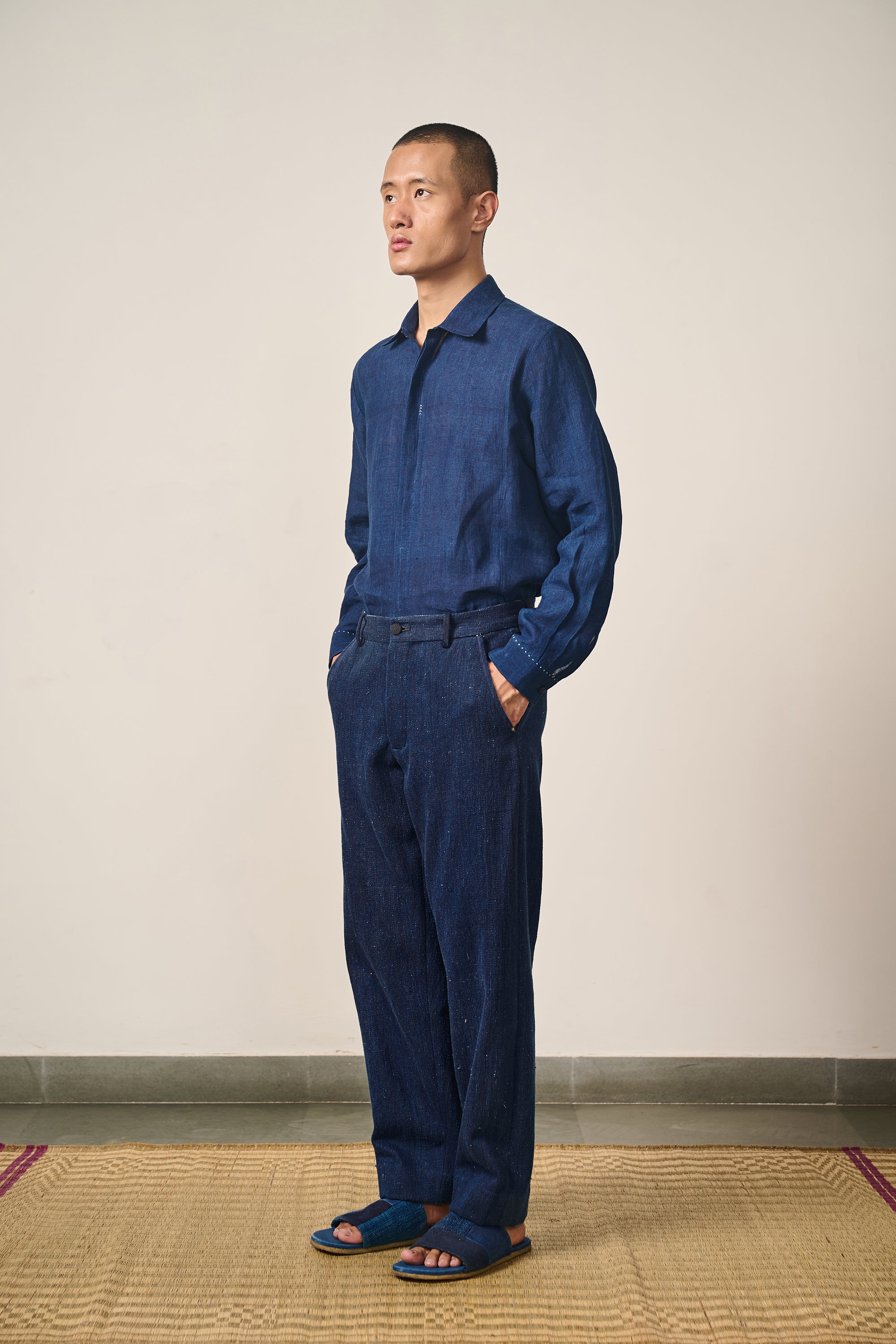 A side shot of a man wearing cotton indigo shirt