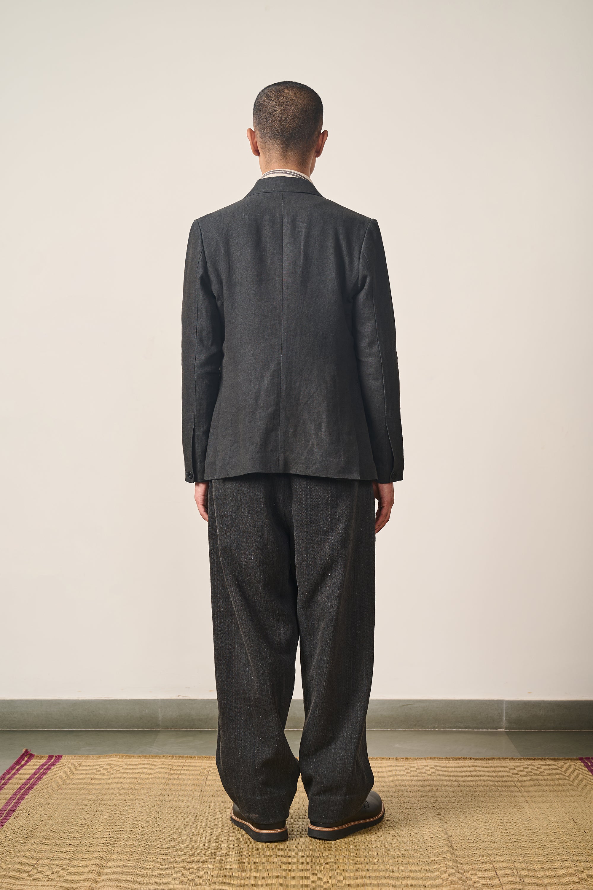 A back shot of a man wearing black jacket