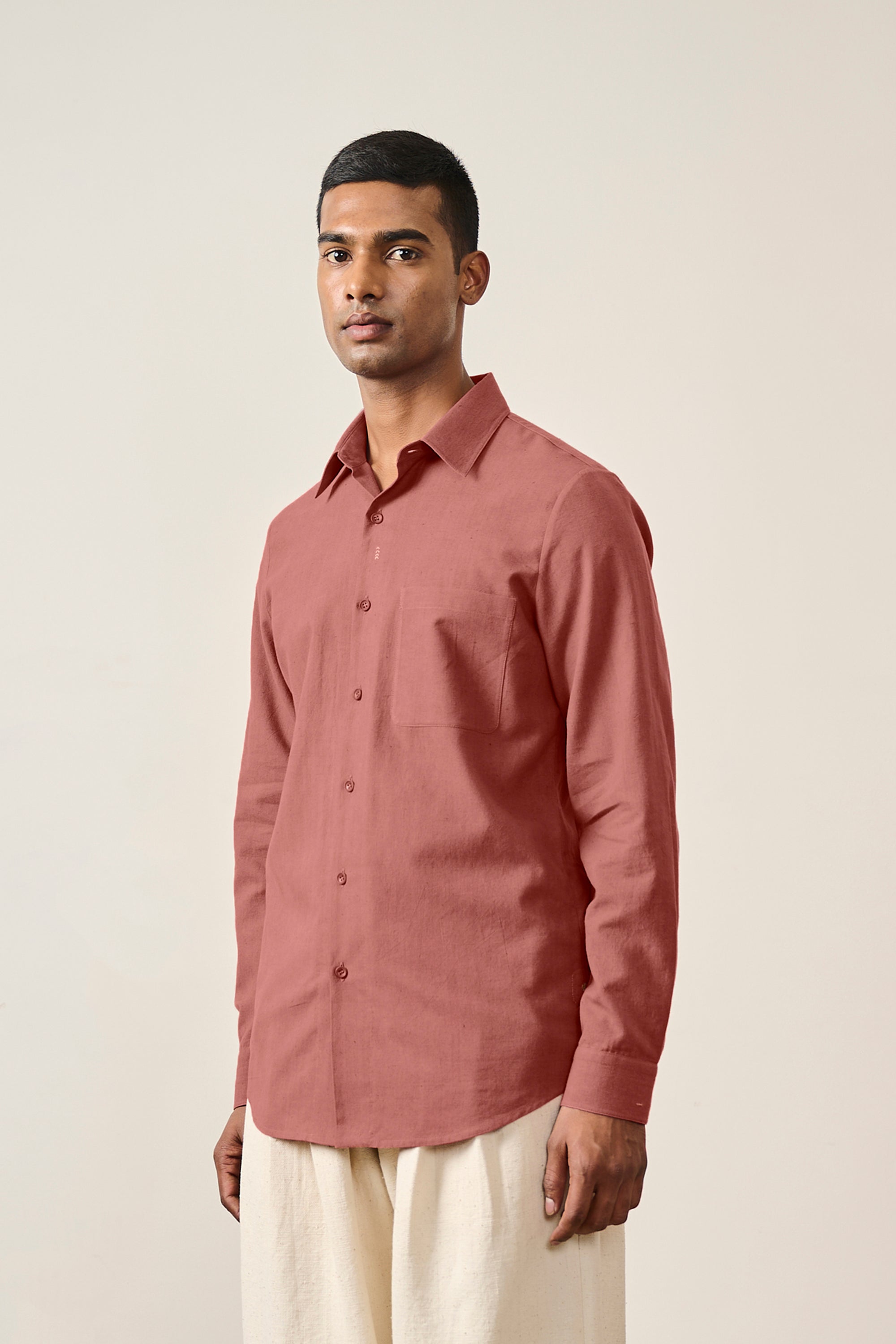 A man wearing rouge pink shirt