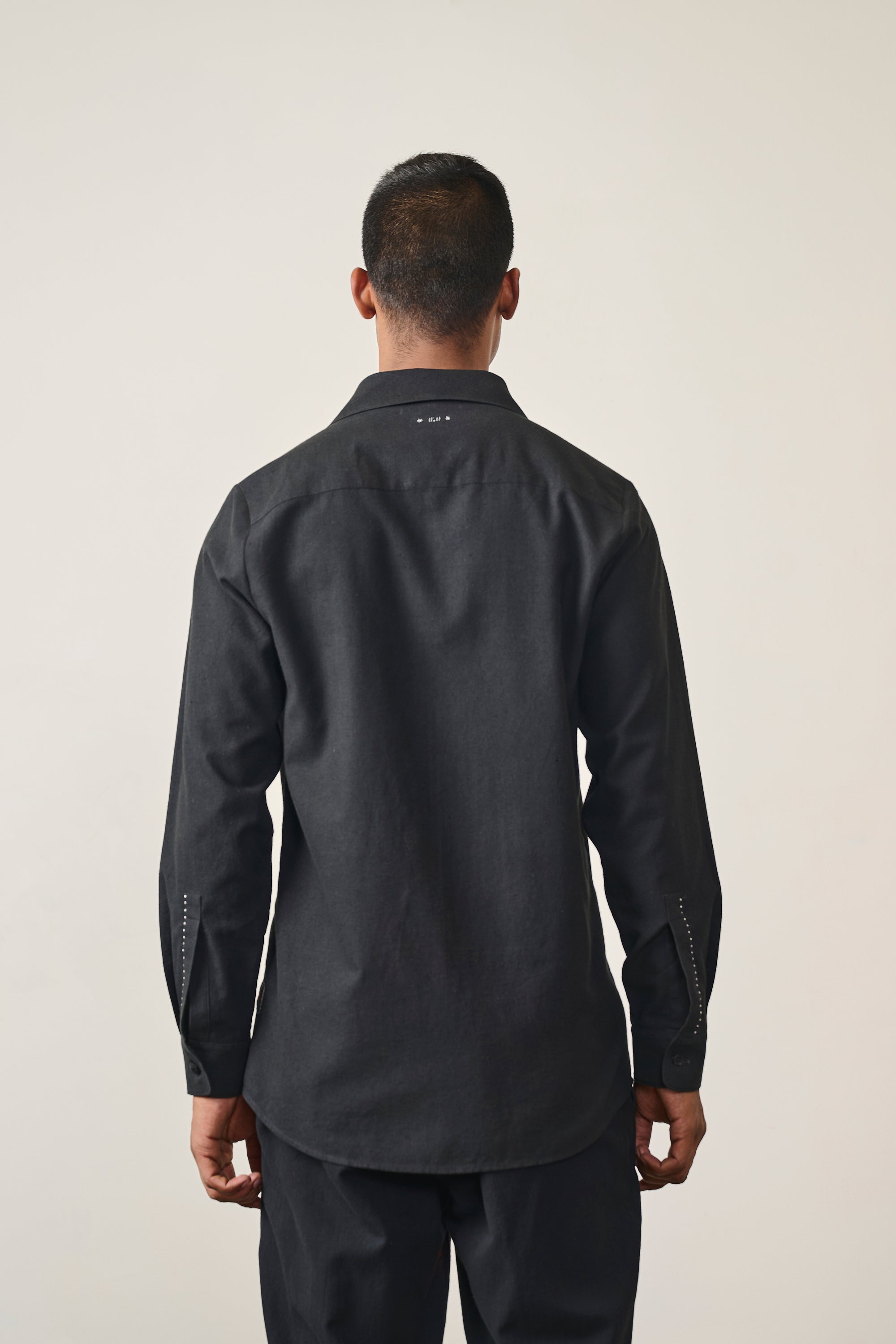 A back shot of man wearing black shirt