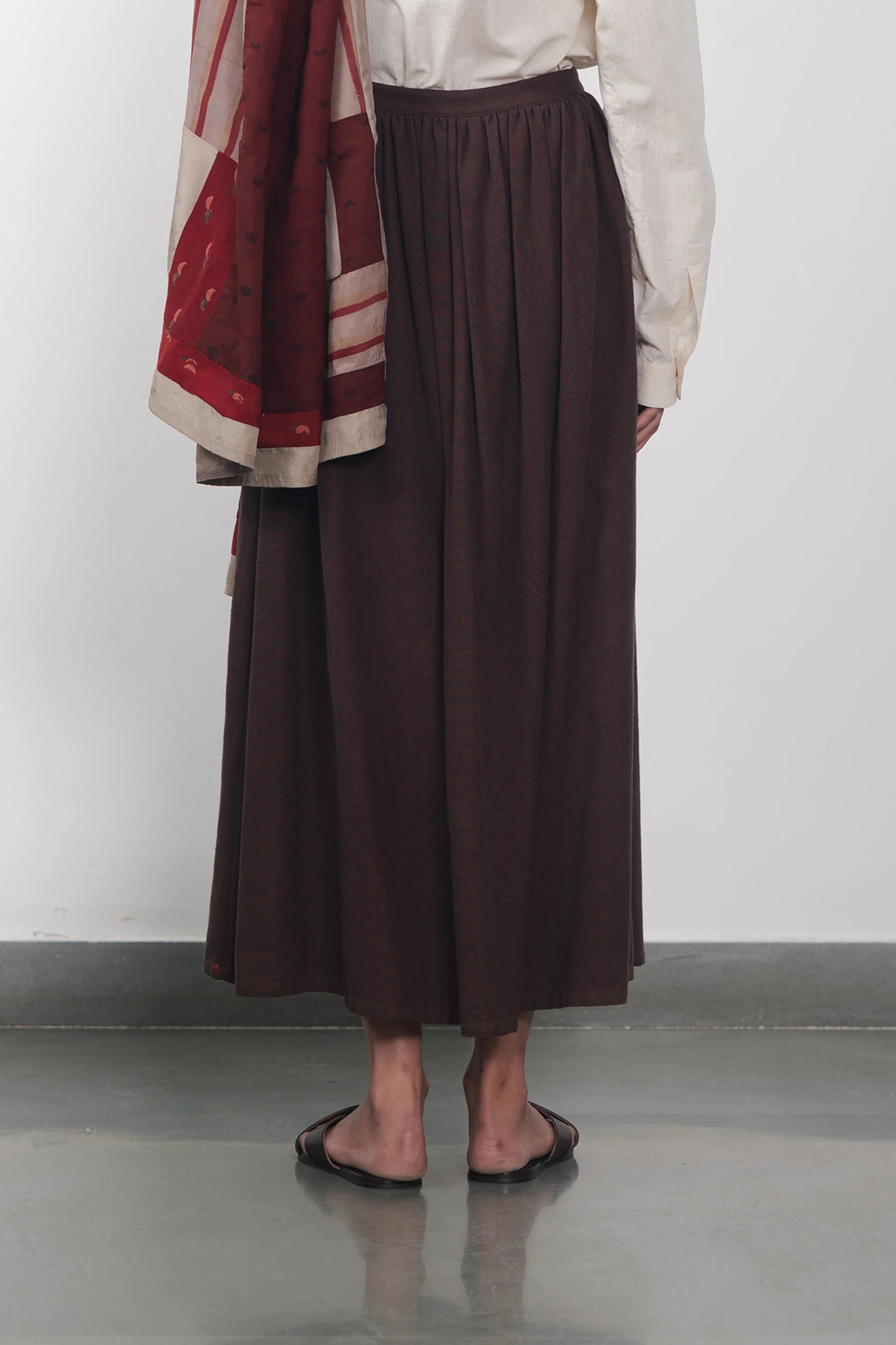Back shot of a women wearing burnt umber skirt