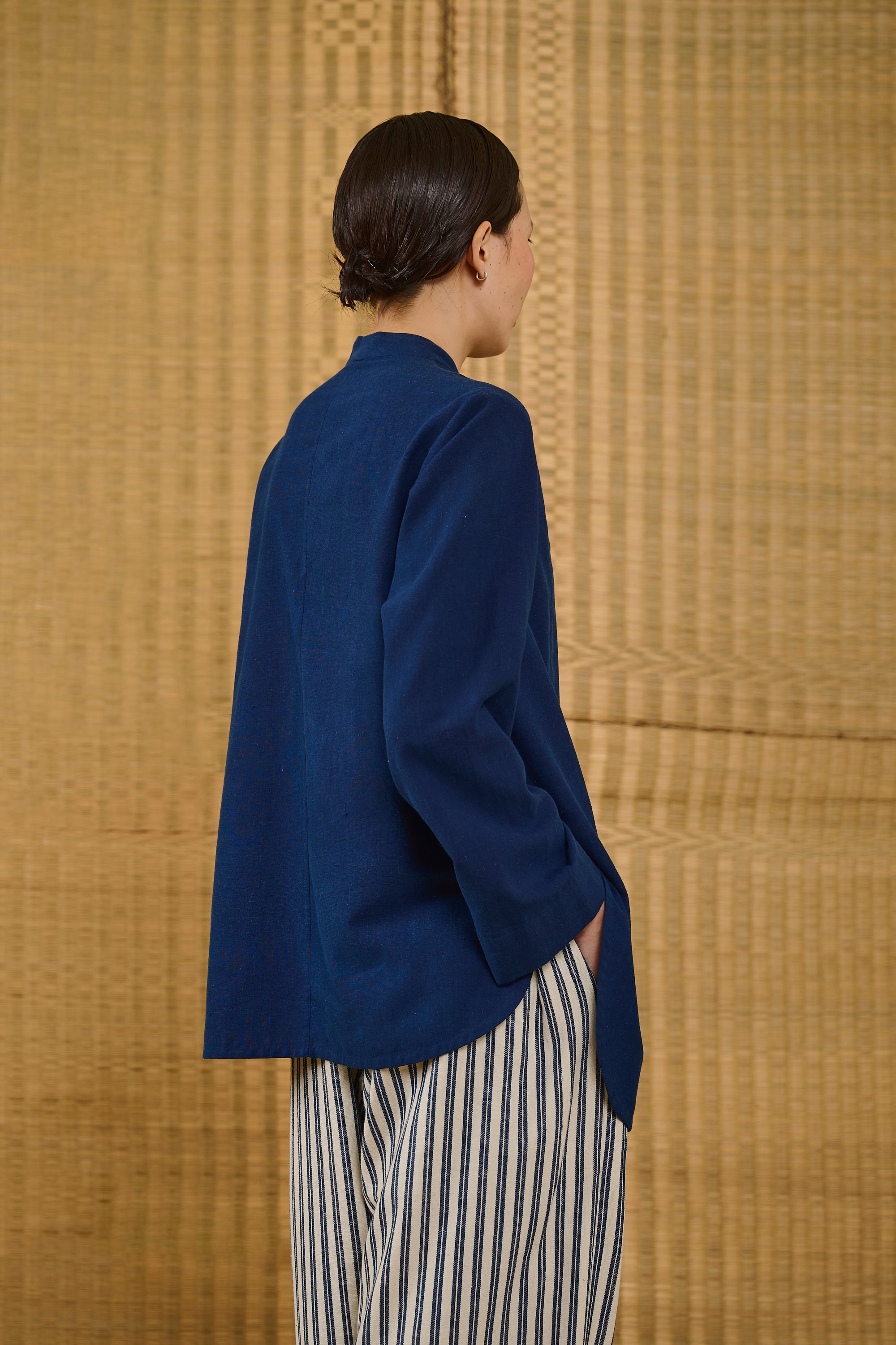 A back shot of a woman wearing indigo shirt