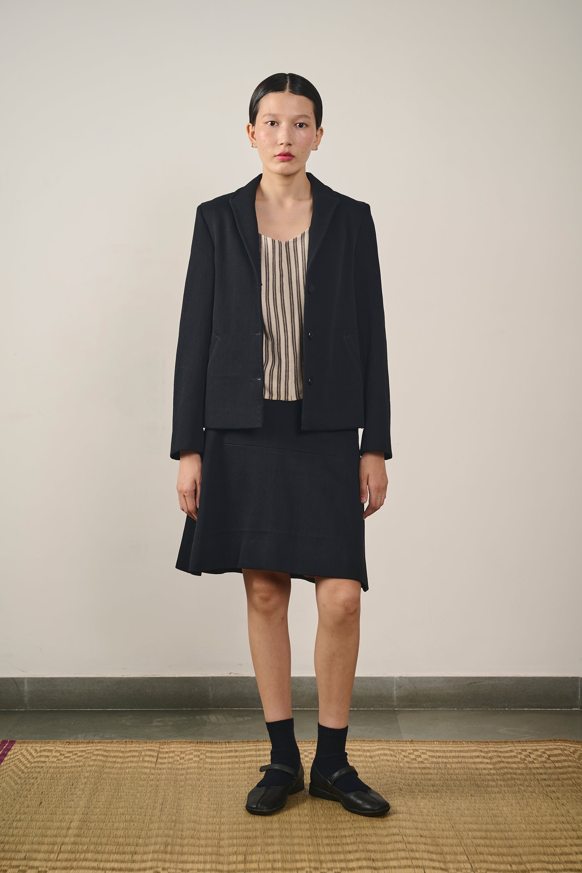 A woman wearing denim black blazer