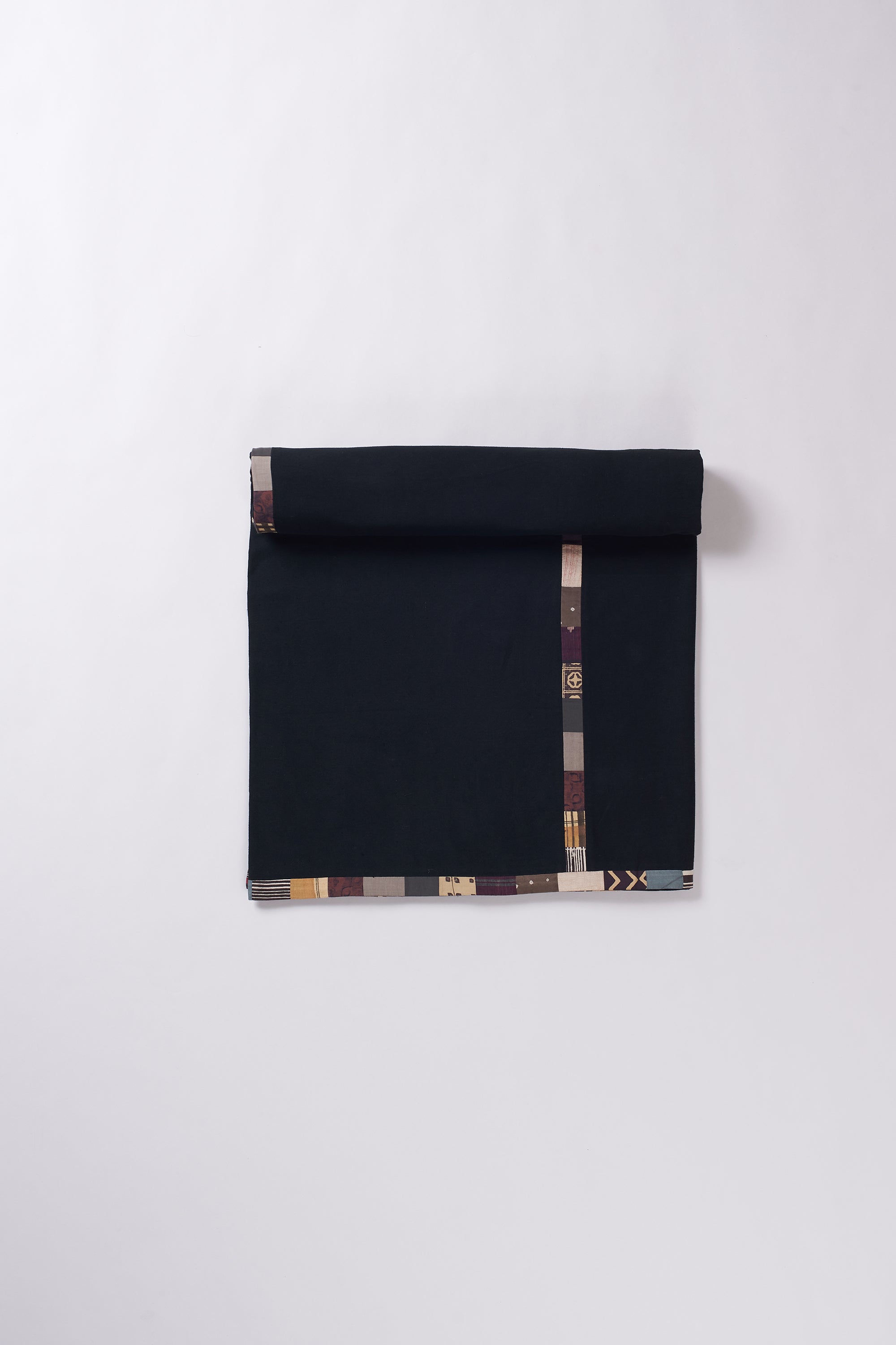 Colorful patterned fabric roll on a white background