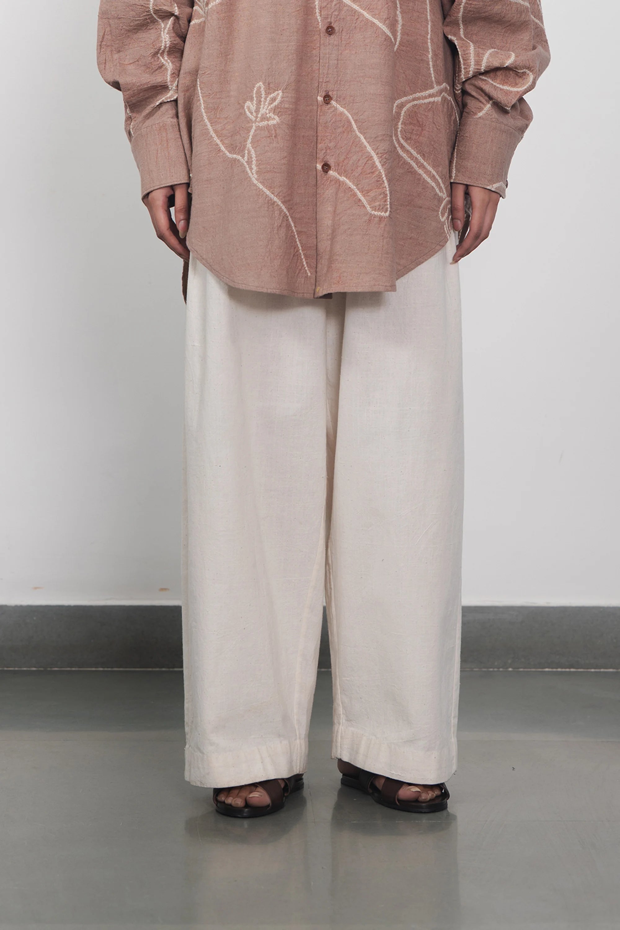 A woman wearing ecru pant