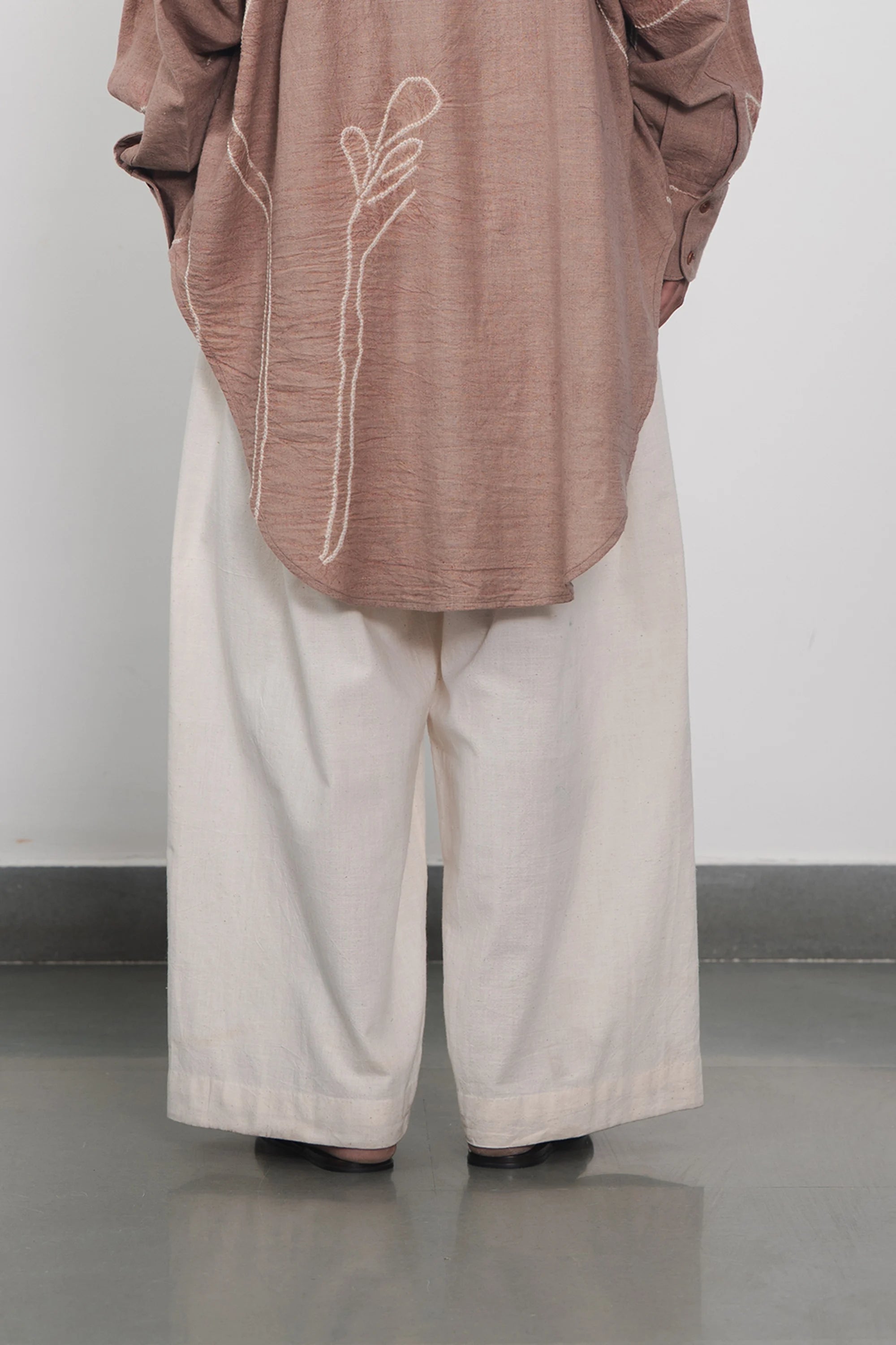 Person wearing ecru cotton pant