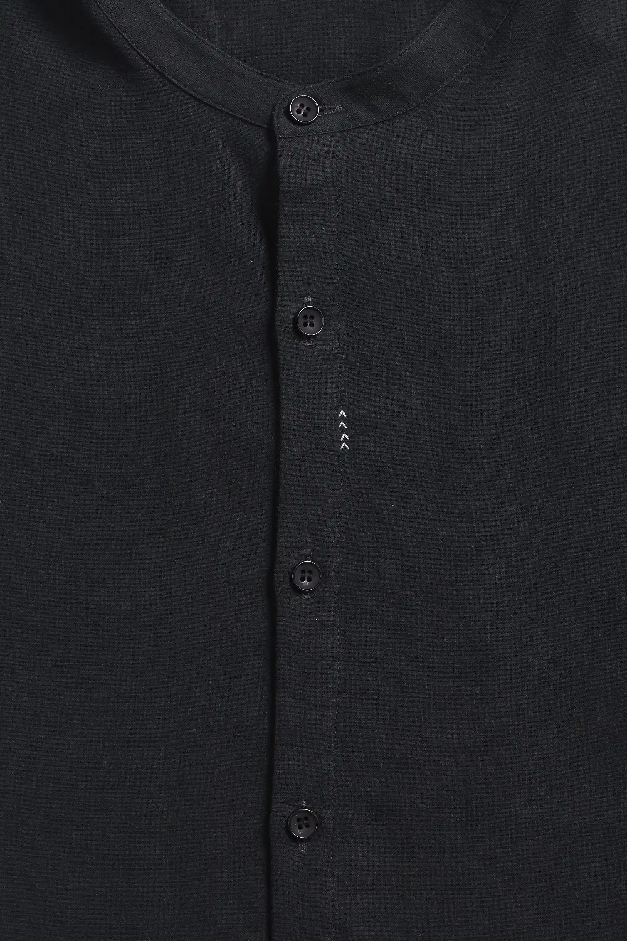 Close-up of a black shirt with a collar and buttons 