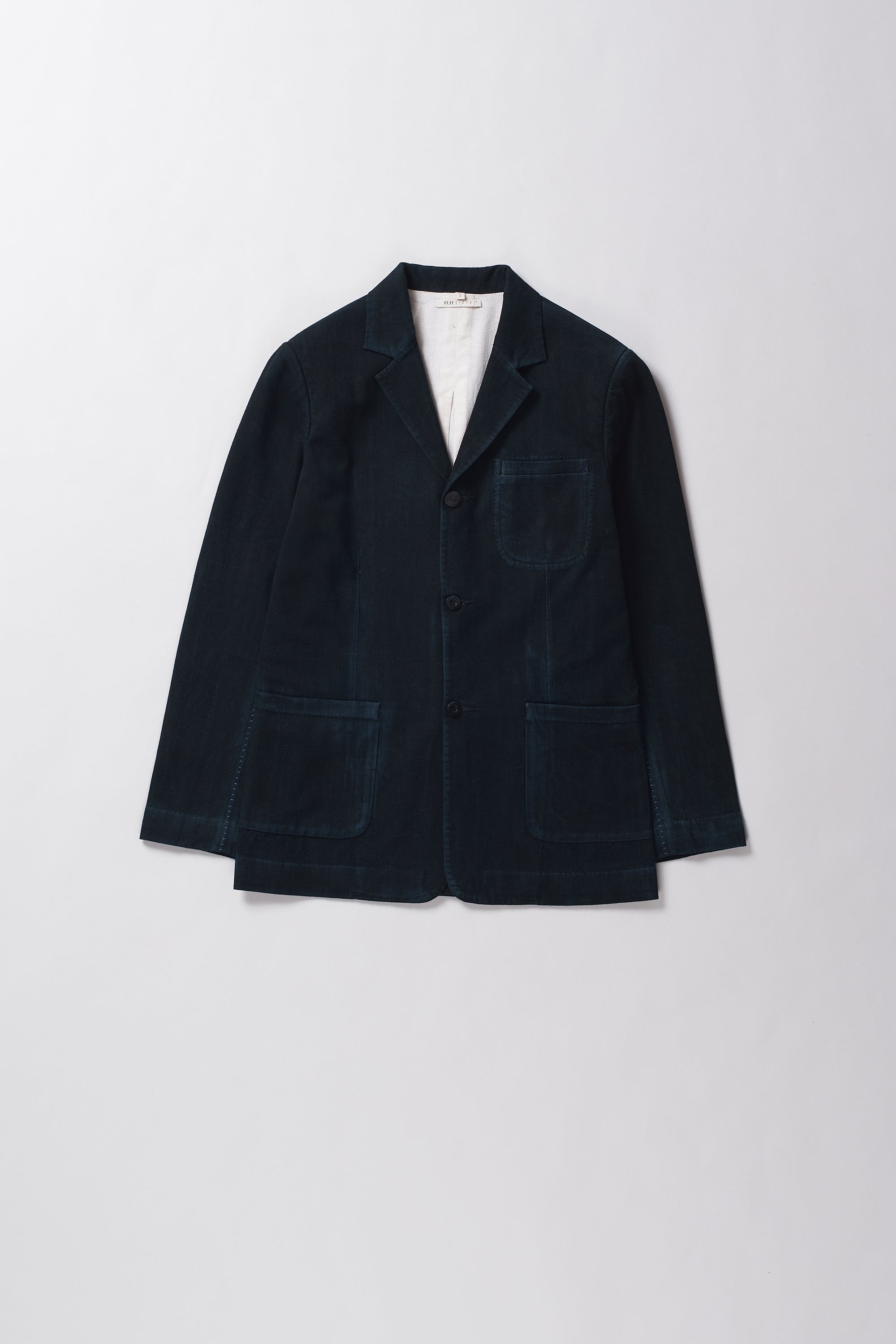 Dark blue blazer on a light grey background