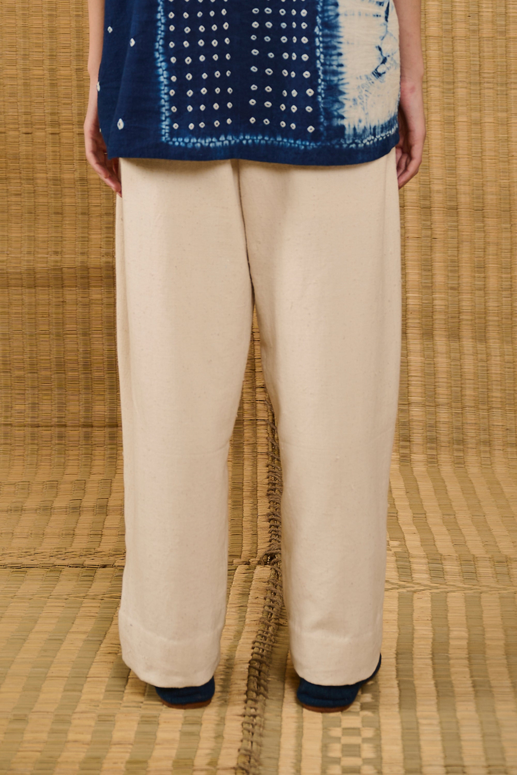 A back shot of a woman wearing ecru cotton pant