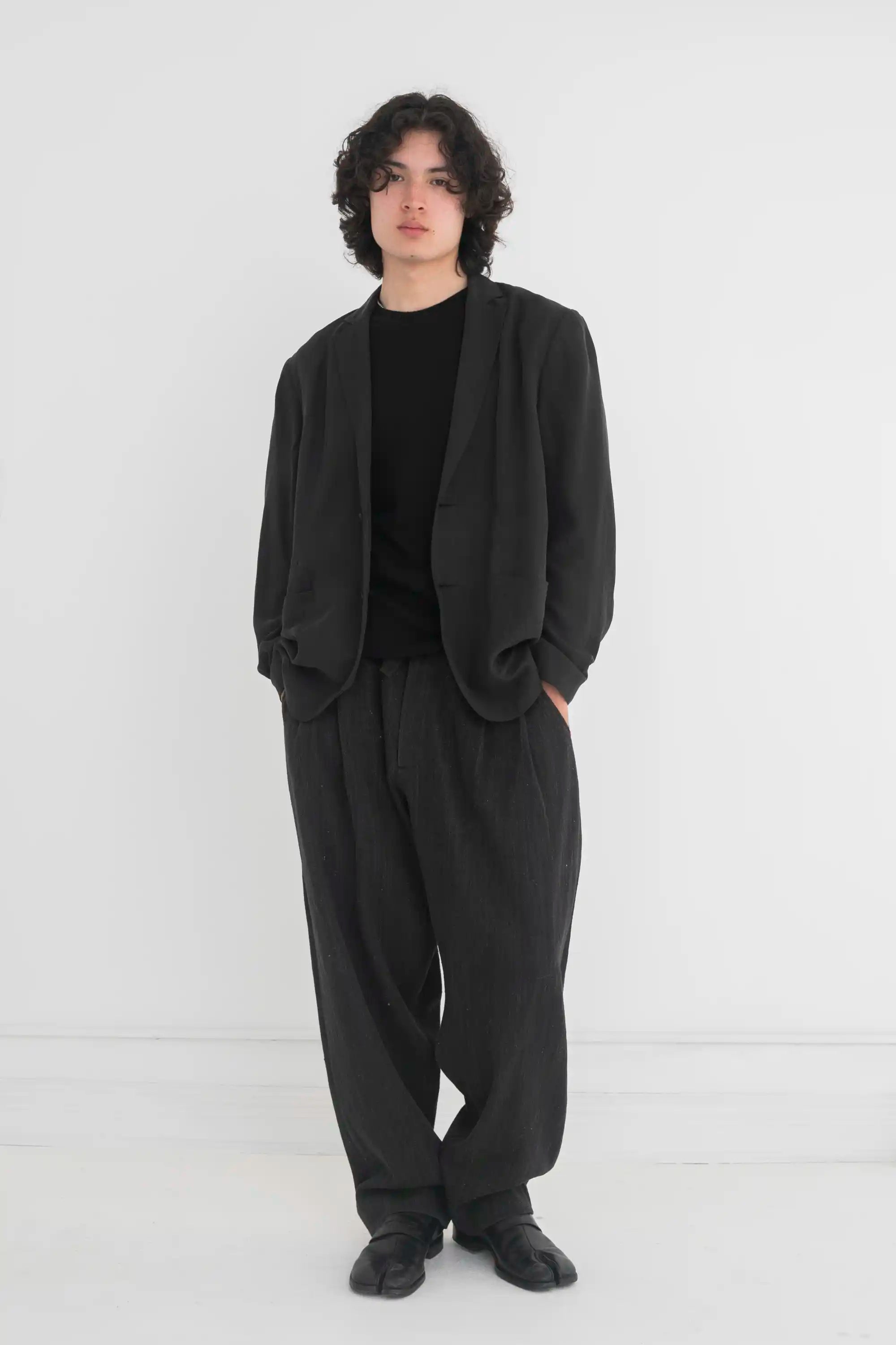 A man wearing black oversized jacket
