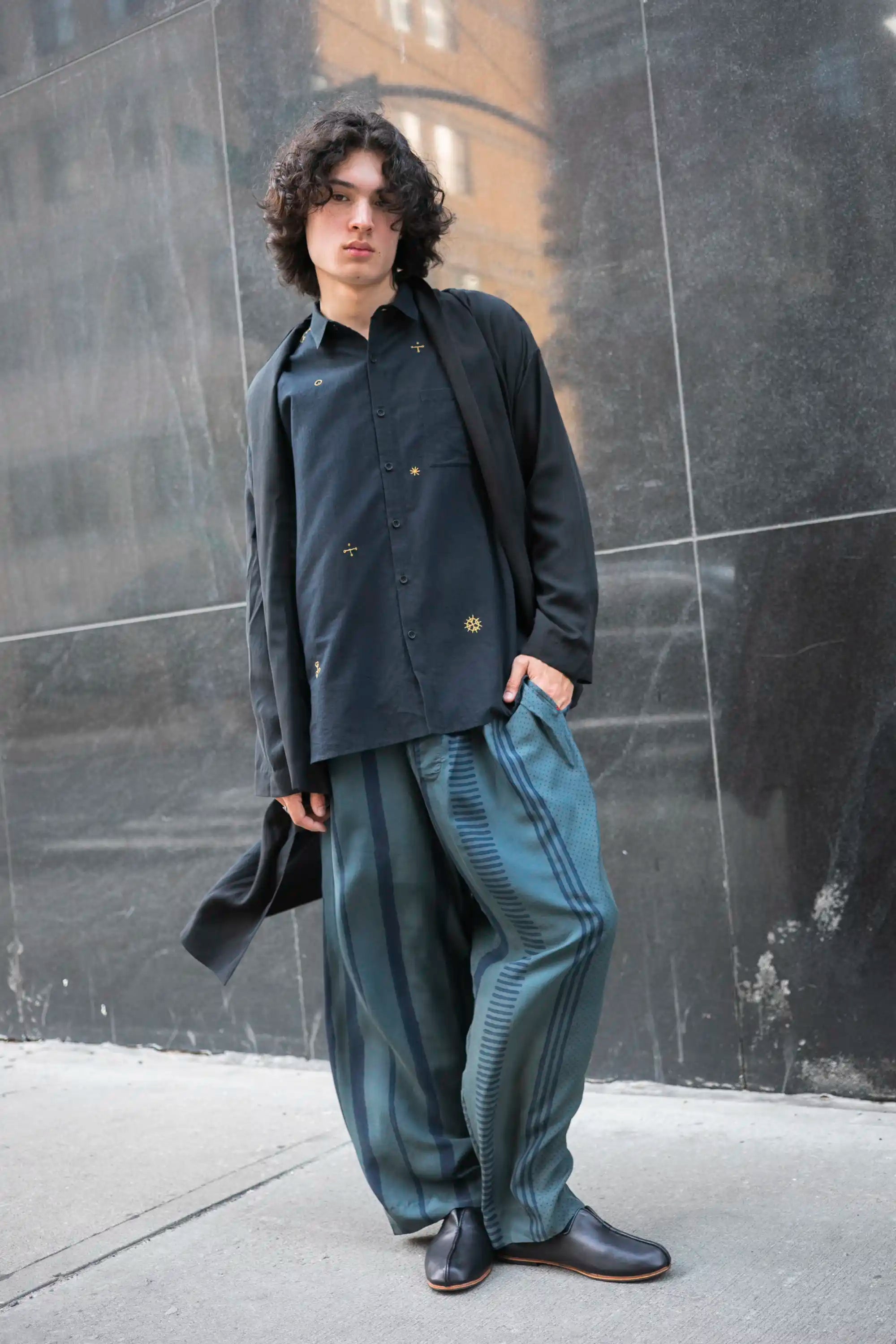 A man wearing black block printed pant