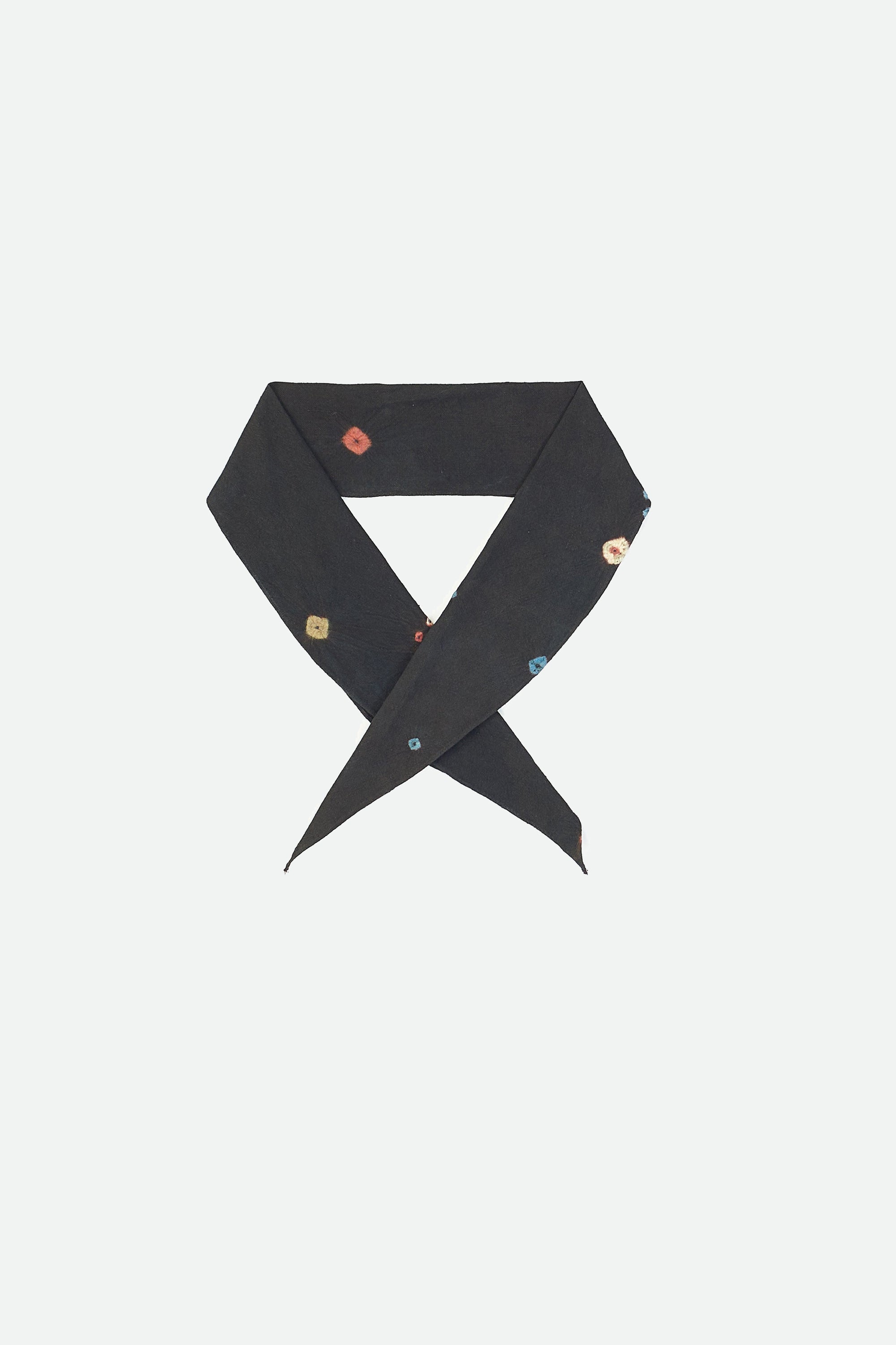 Midnight indigo  folded bandana with colourful bandhani on a grey background