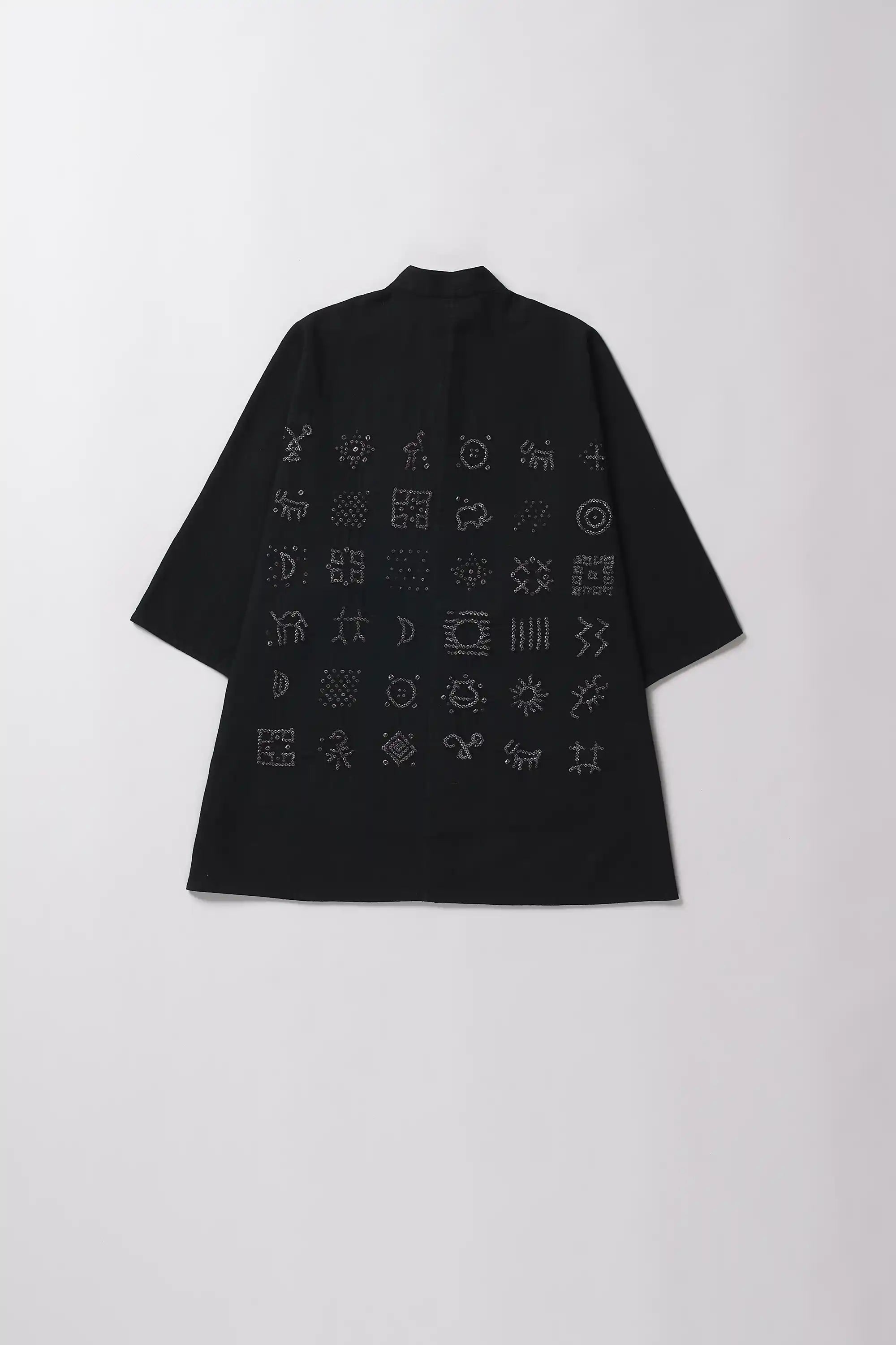 Black shirt with geometric pattern on a white background