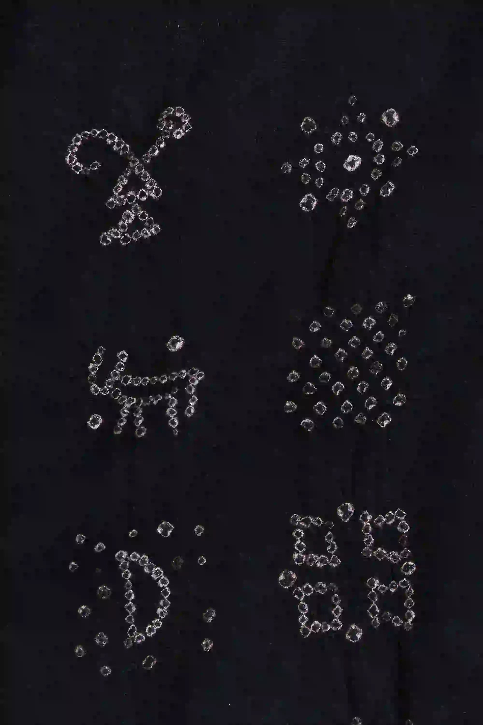 Black fabric close-up with white Bandhani designs a shirt