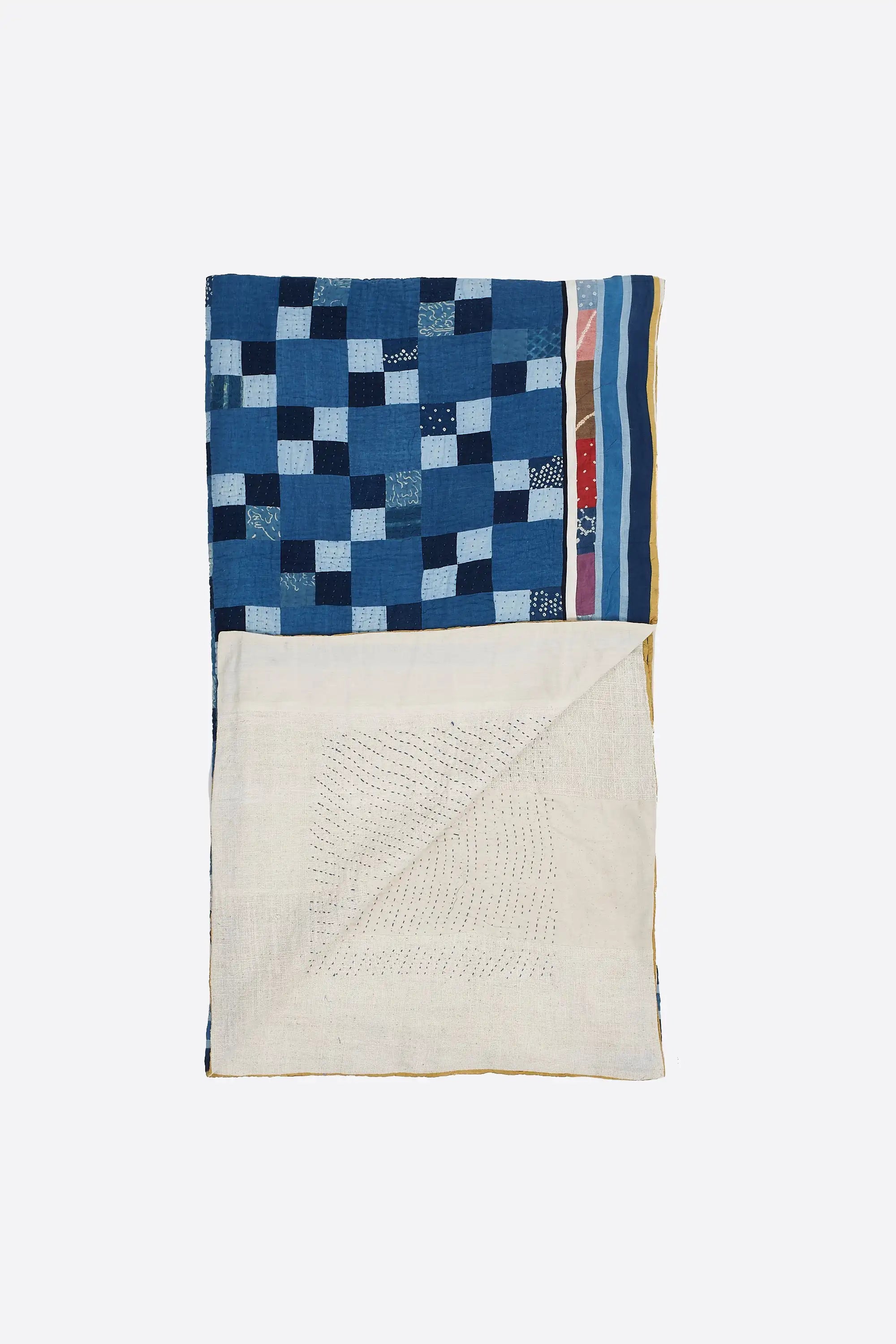 Folded indigo quilt with patchwork