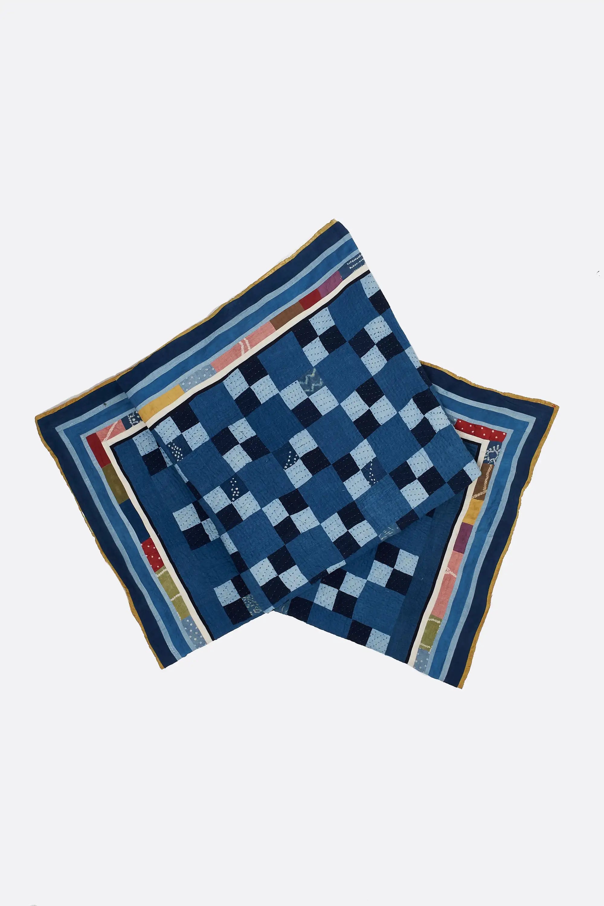 Blue checkered fabric with colorful border on a white background