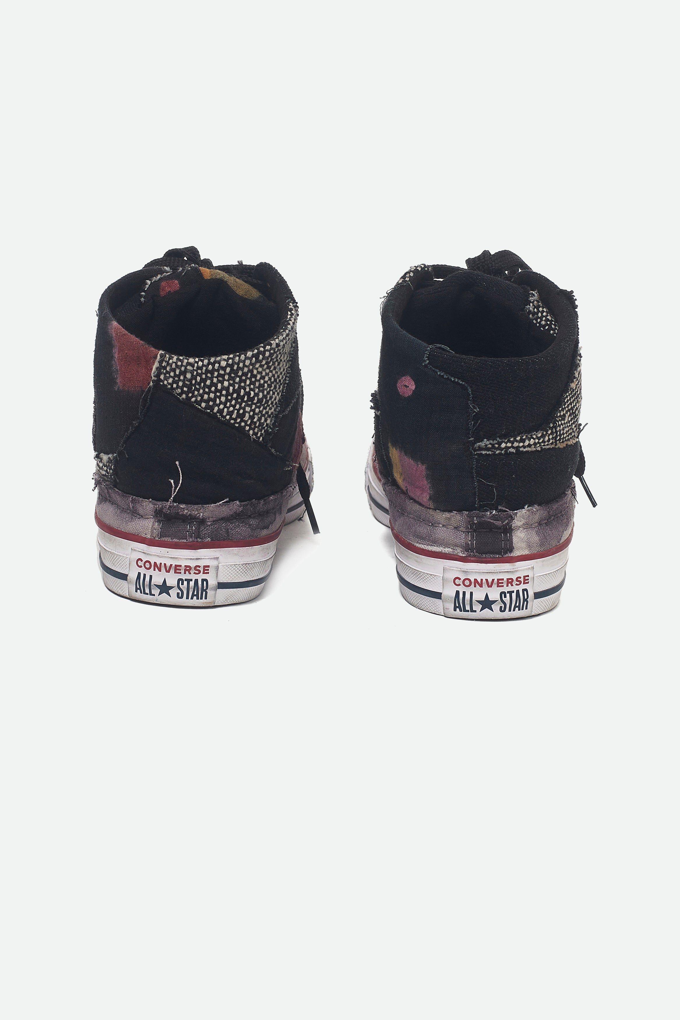 A back shot of a black converse shoes