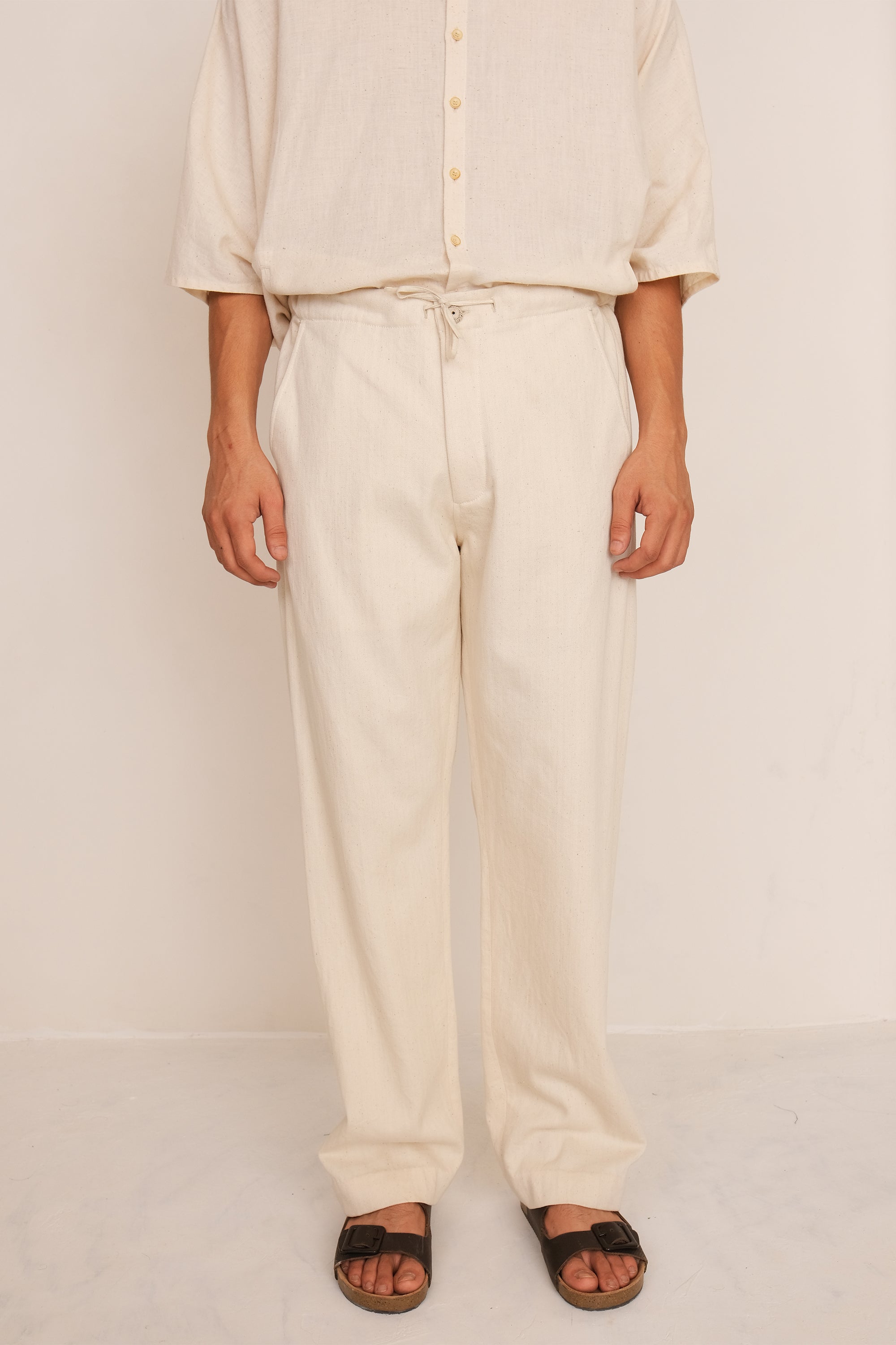A man wearing ecru pant