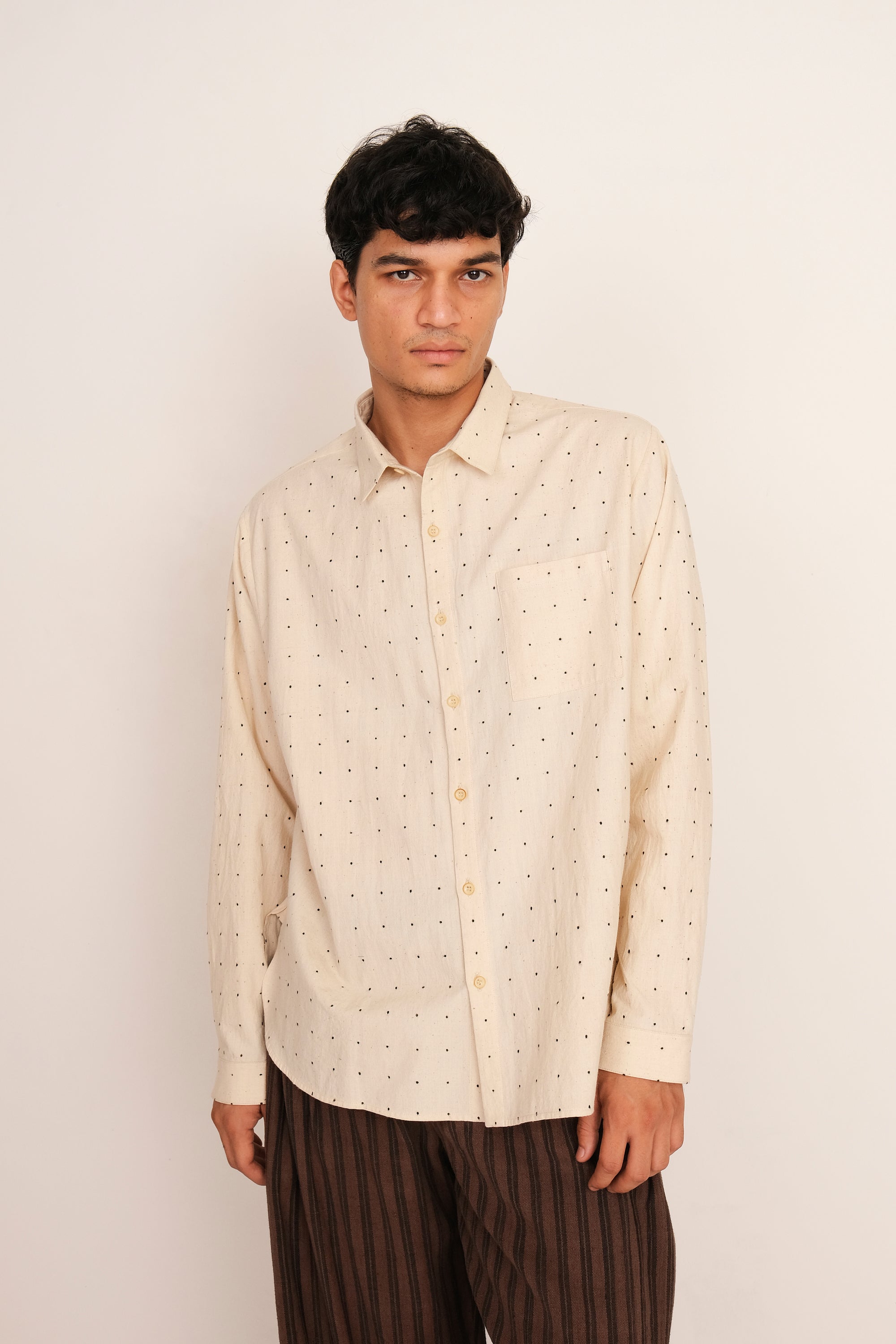 A man wearing ecru tangaliya shirt