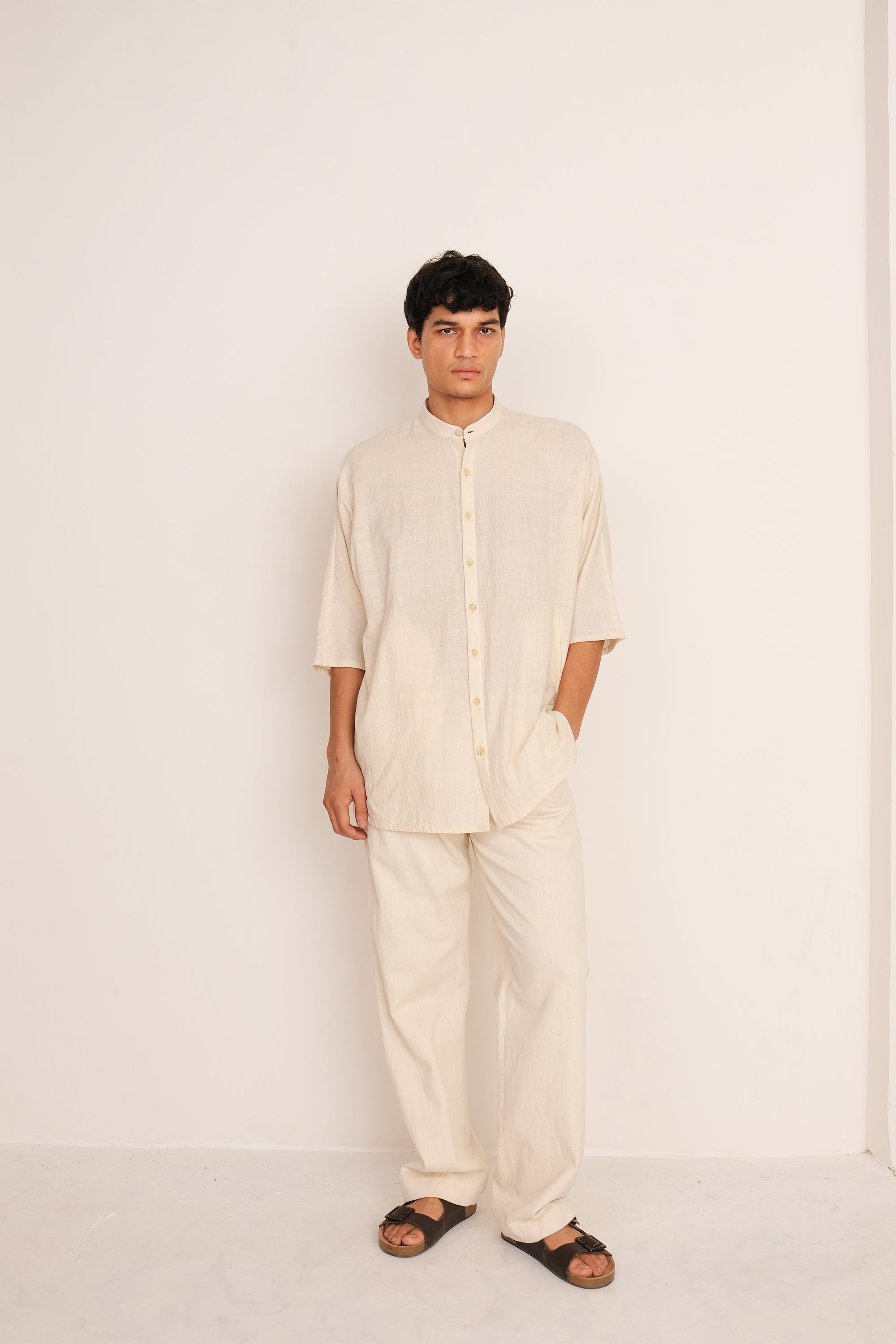 A man wearing ecru shirt