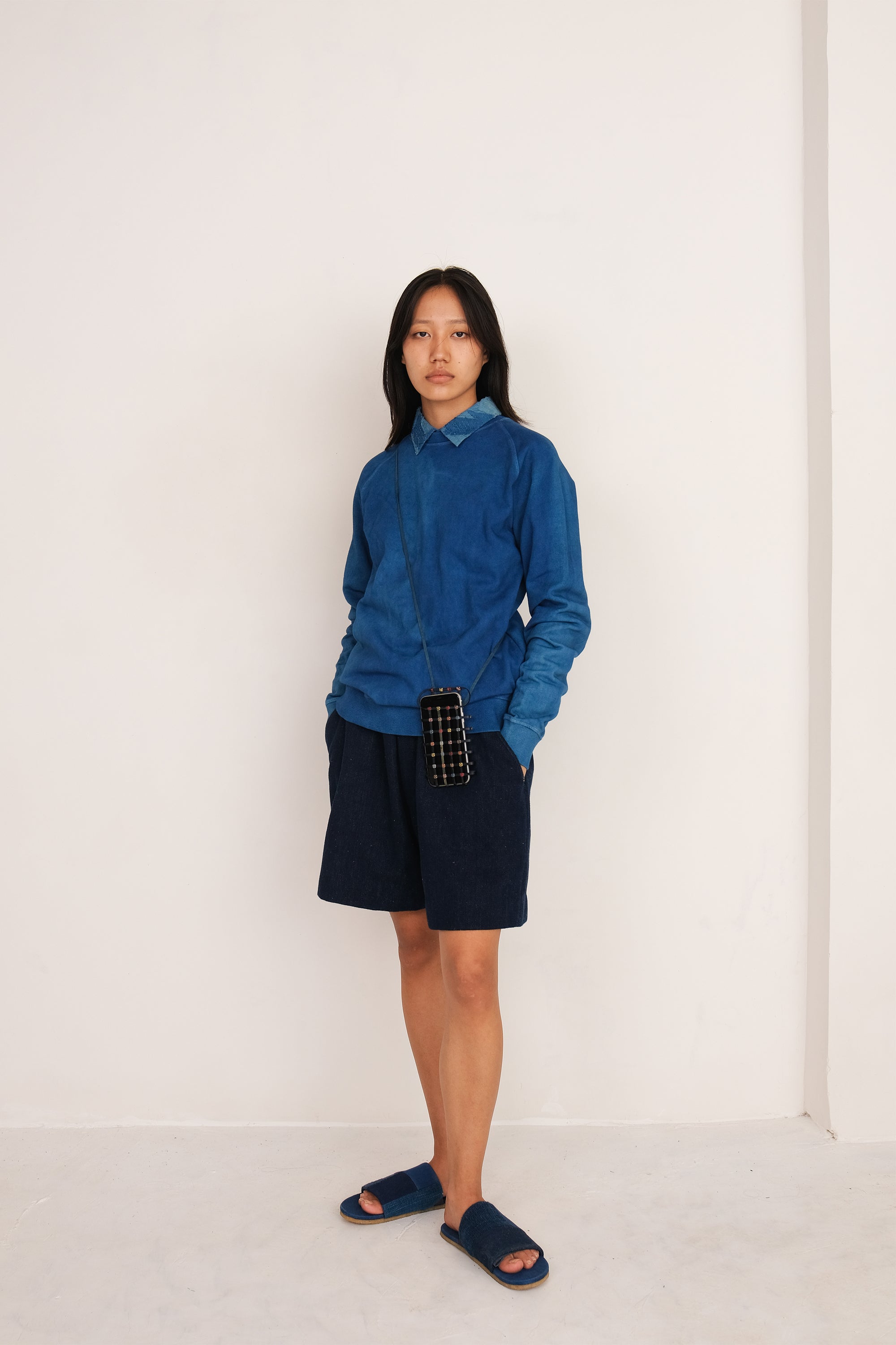A woman wearing indigo cotton sweatshirt