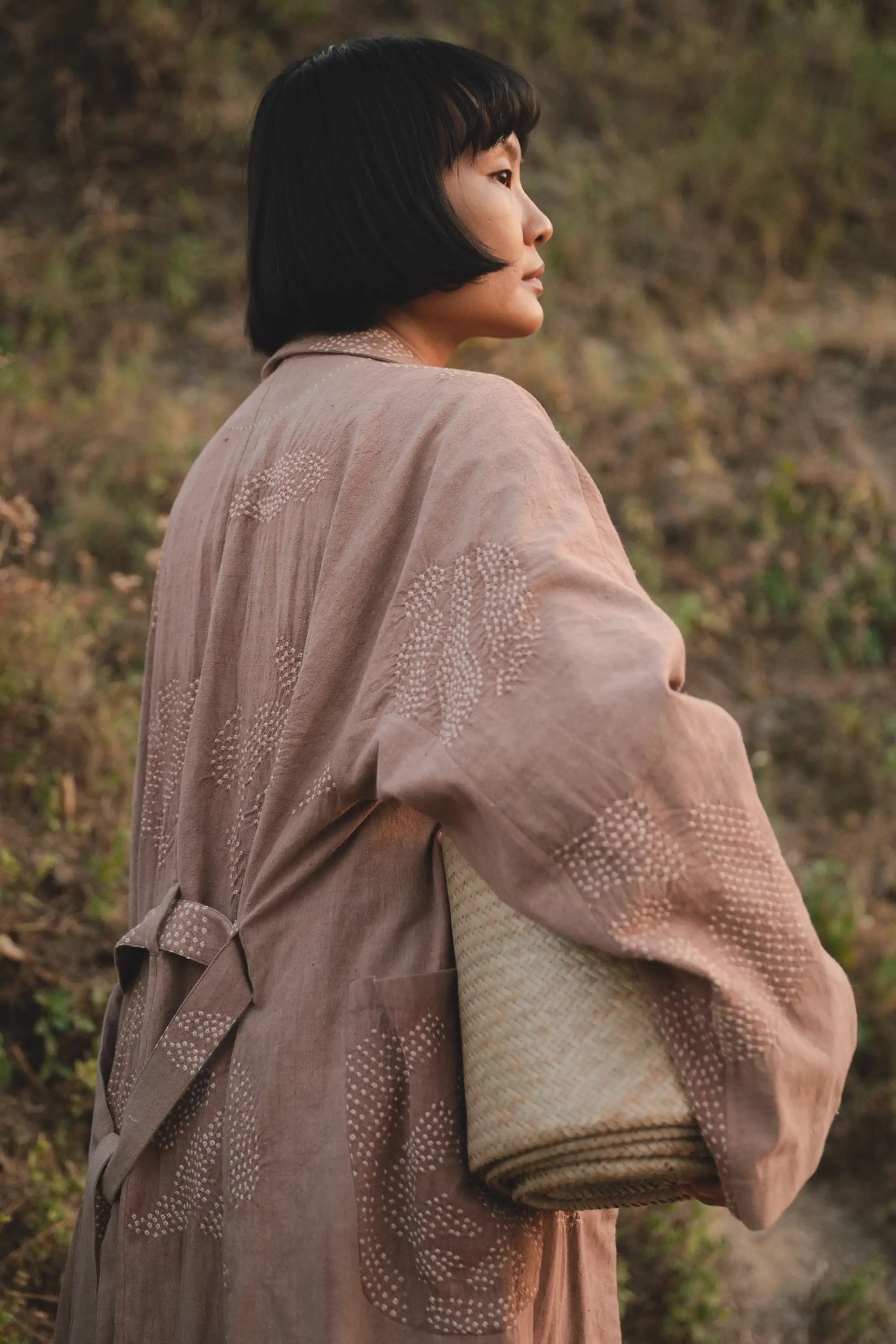 A back shot of a women wearing old rose cotton shrug