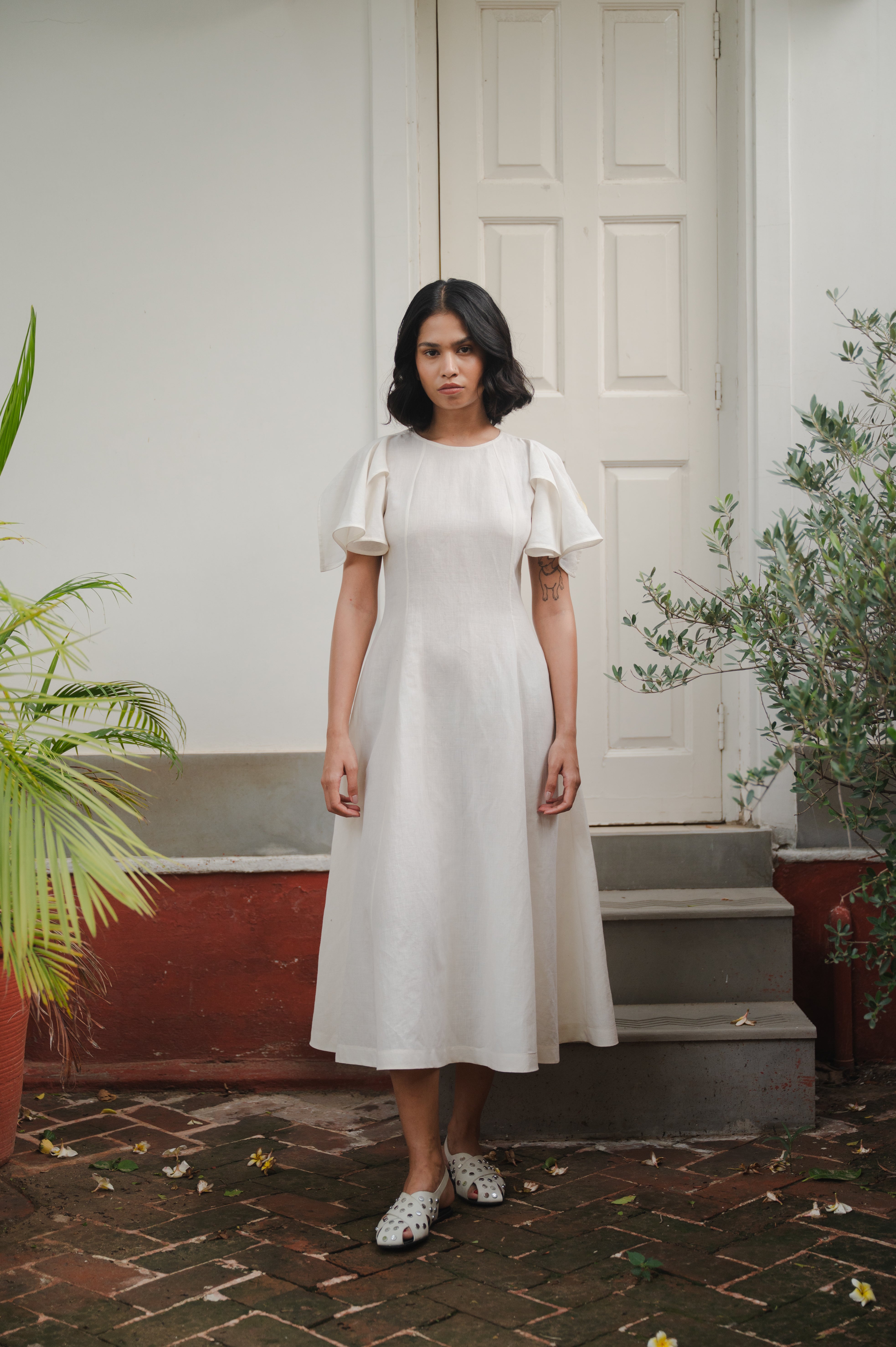 A woman wearing ecru dress