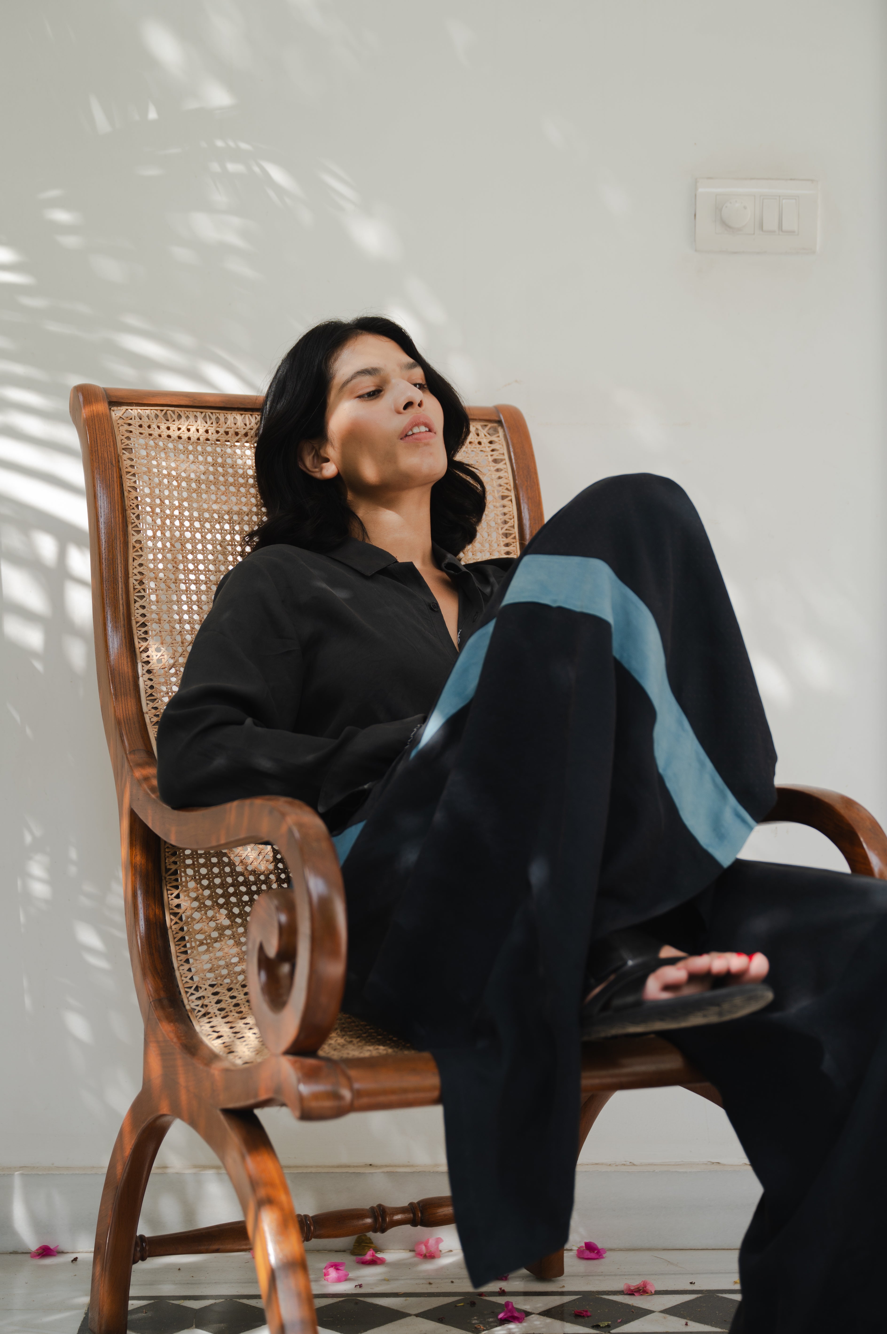 A woman wearing black silk trouser