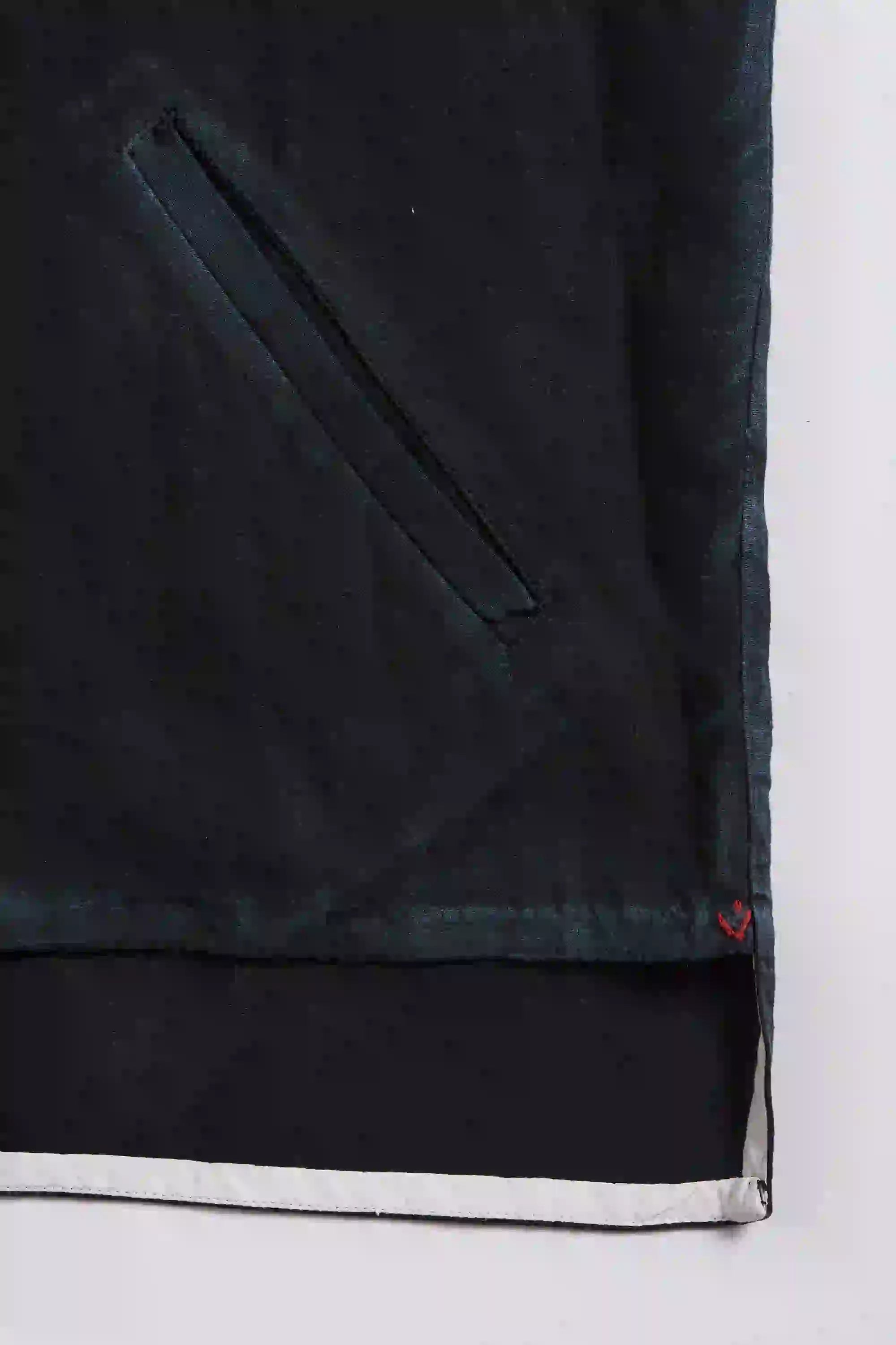 Close-up of a black fabric with a white border on a grey background