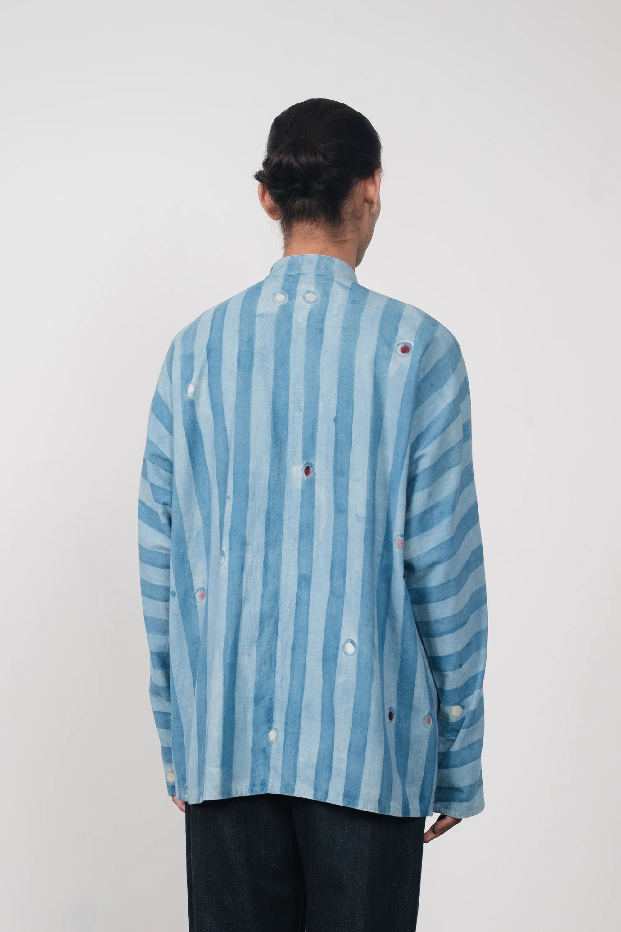 A man wearing light indigo shirt