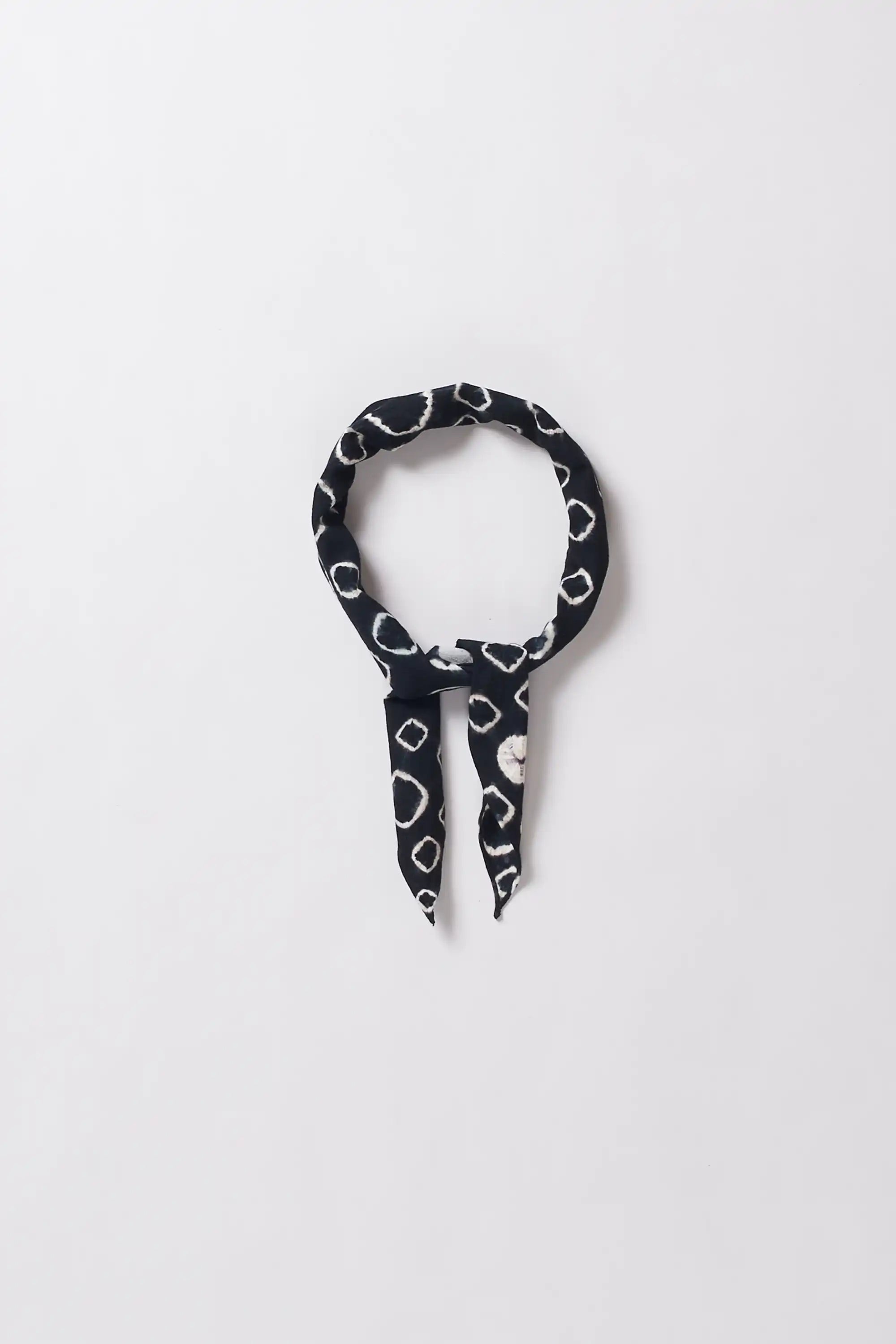 Black and white patterned bandana on a light grey background