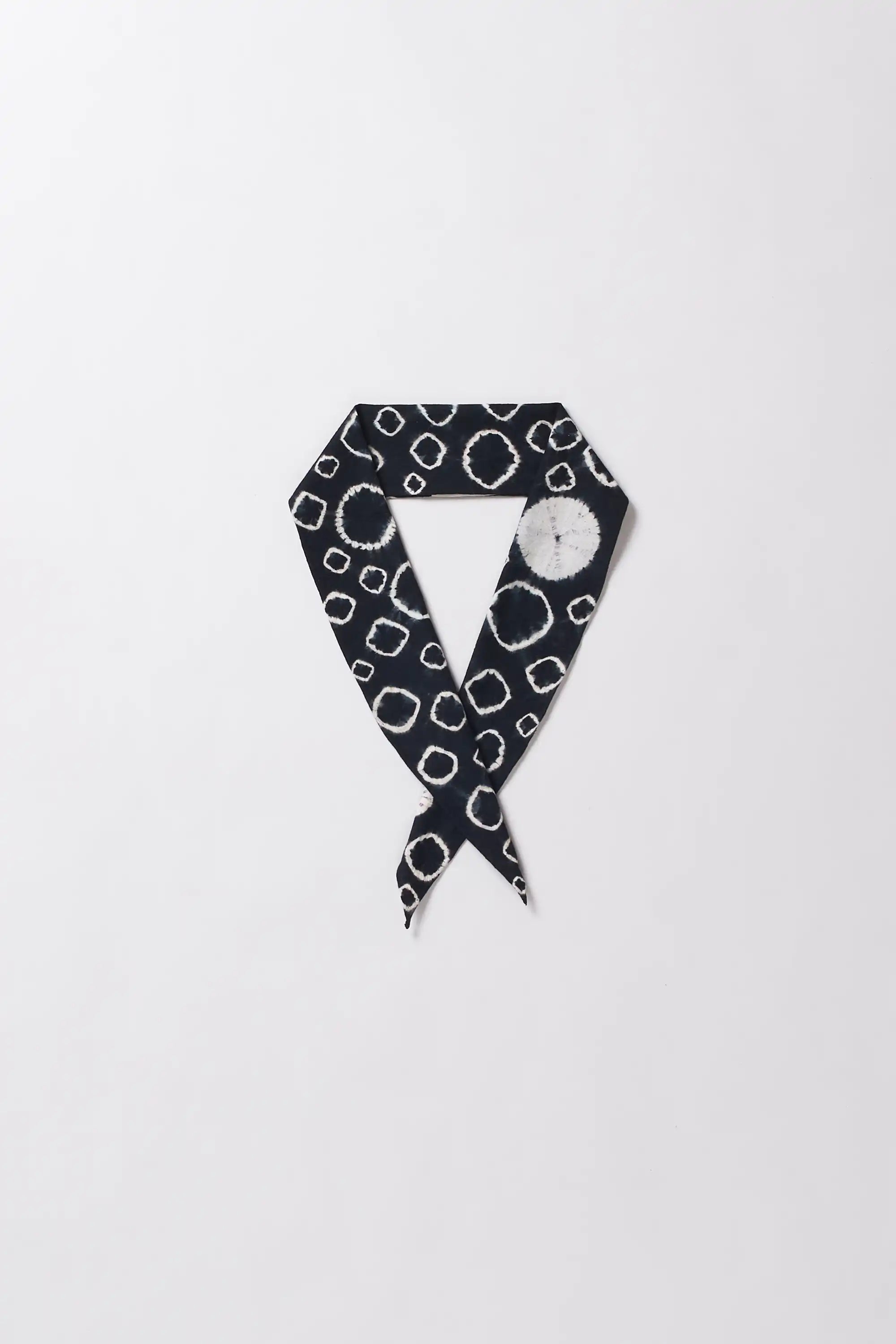 Black and white patterned scarf on a light grey background