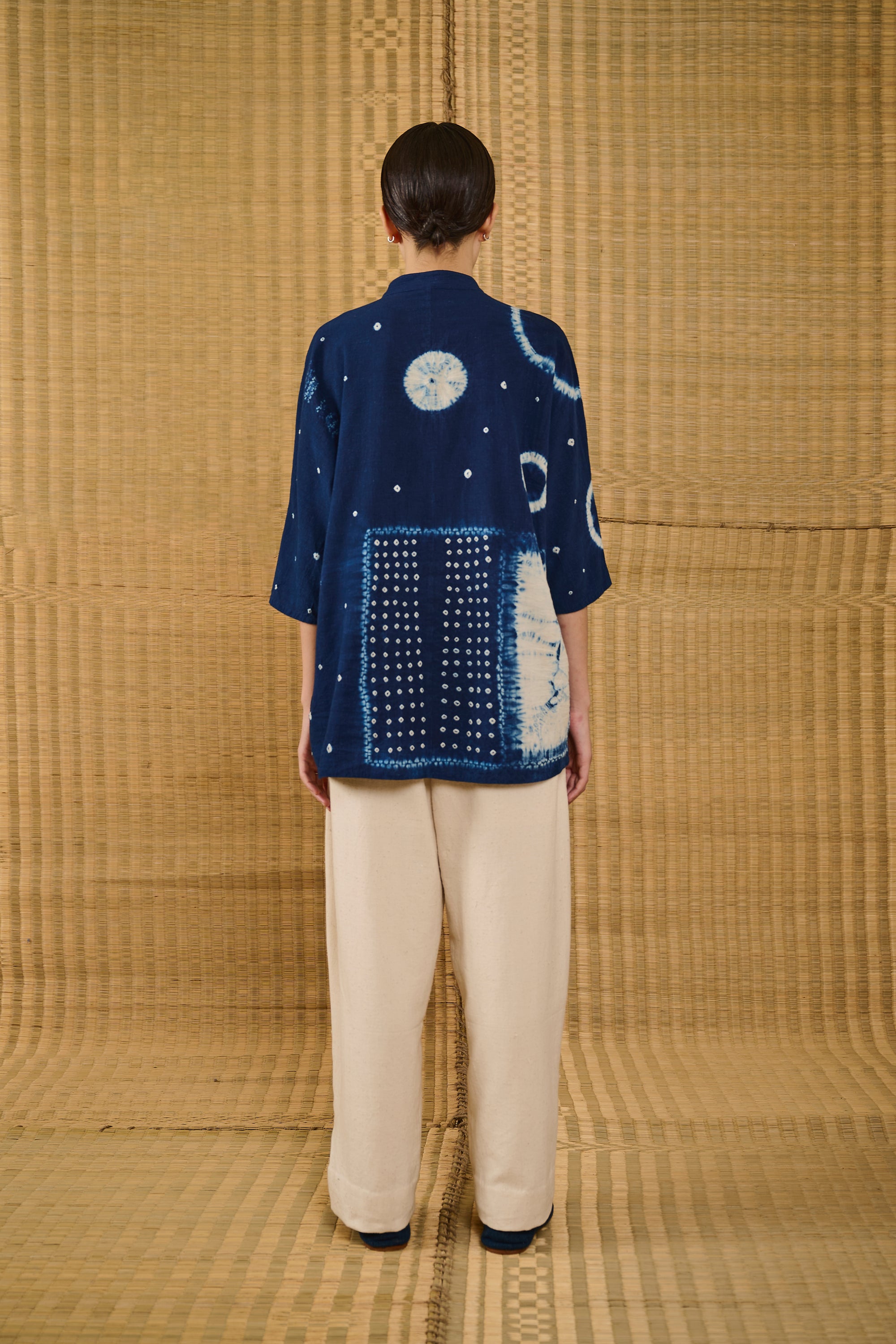 A back shot of a woman wearing indigo shirt 
