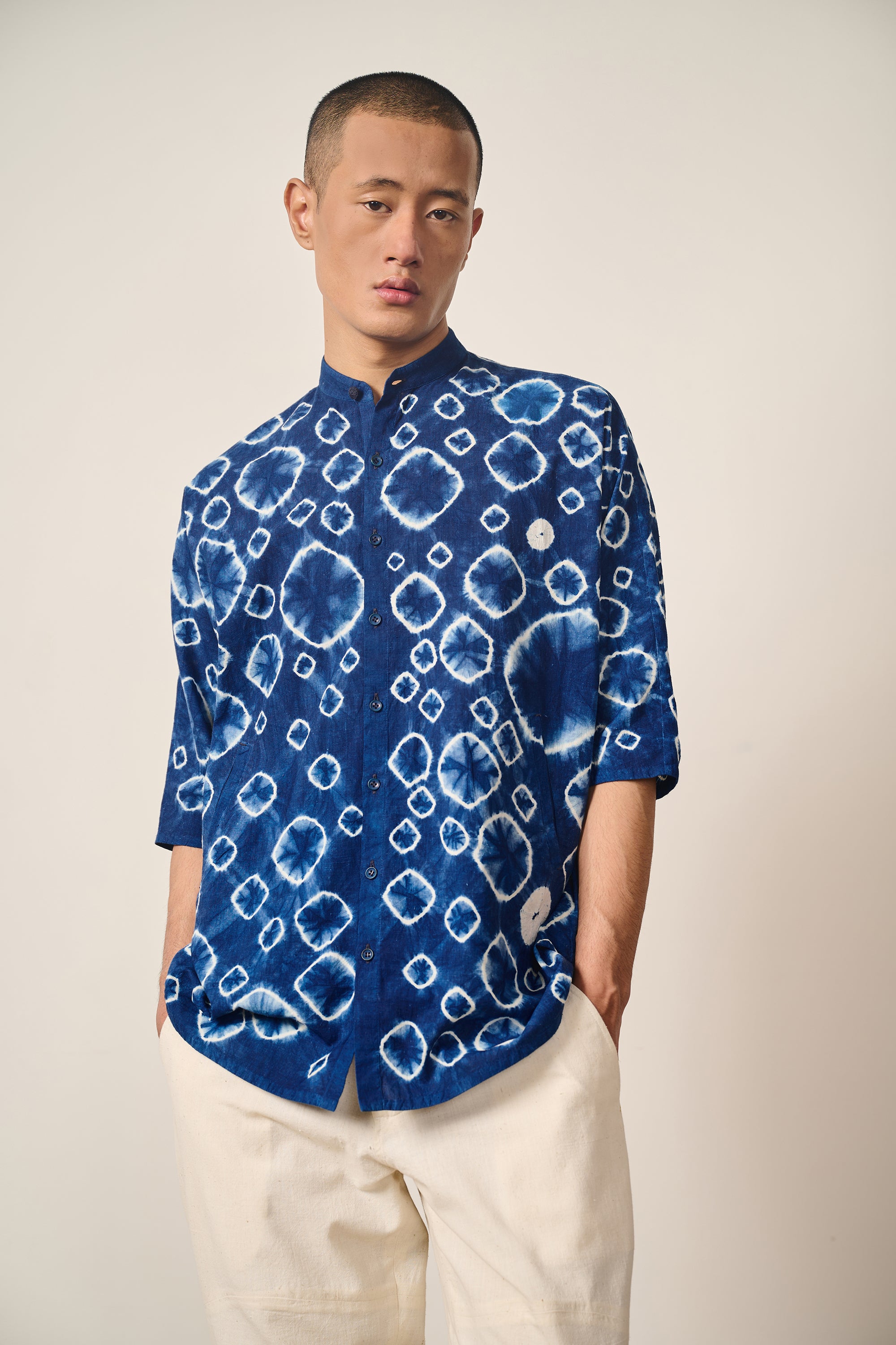 A man wearing indigo shibori shirt
