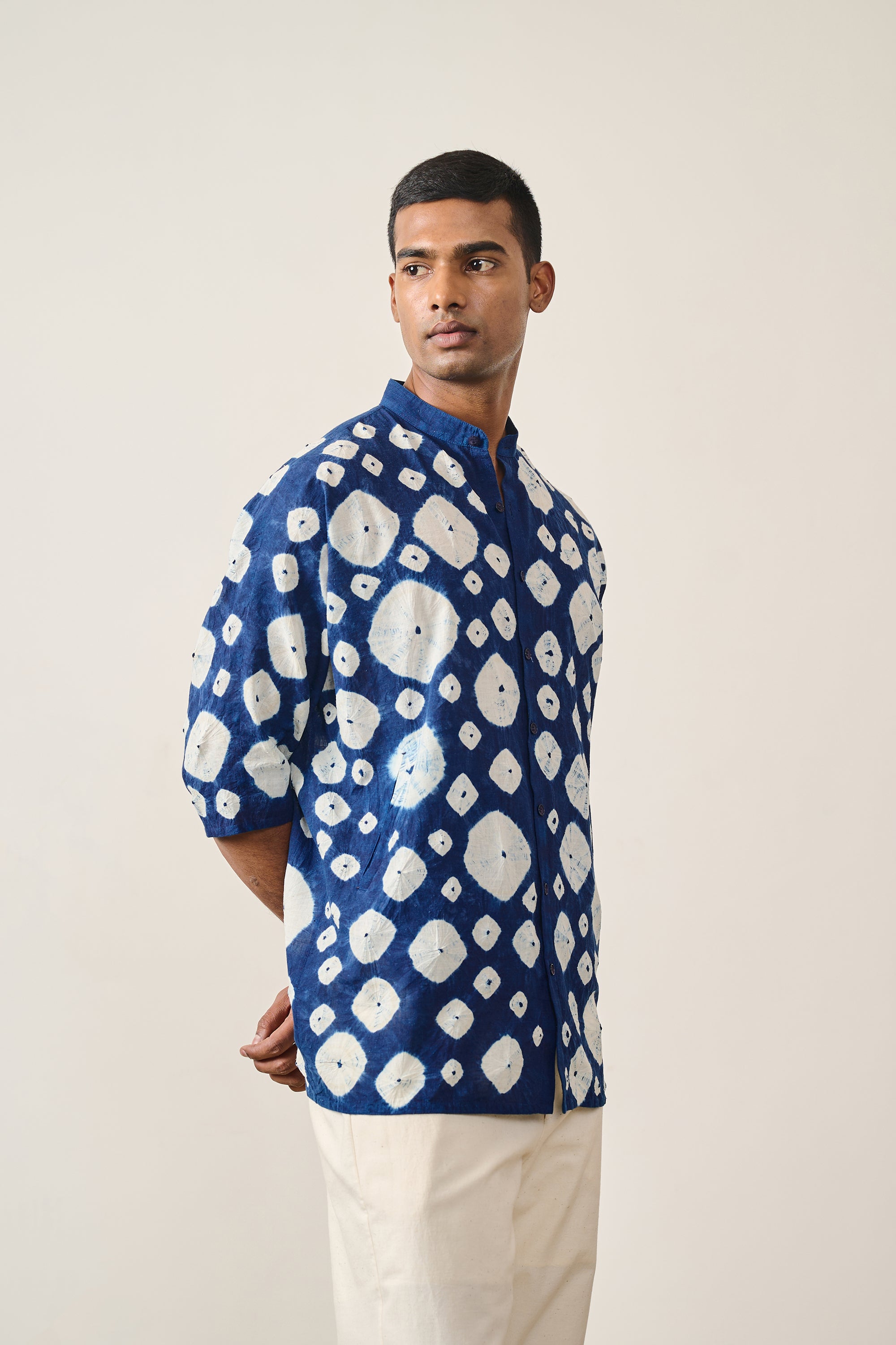 A man wearing medium indigo cotton shirt
