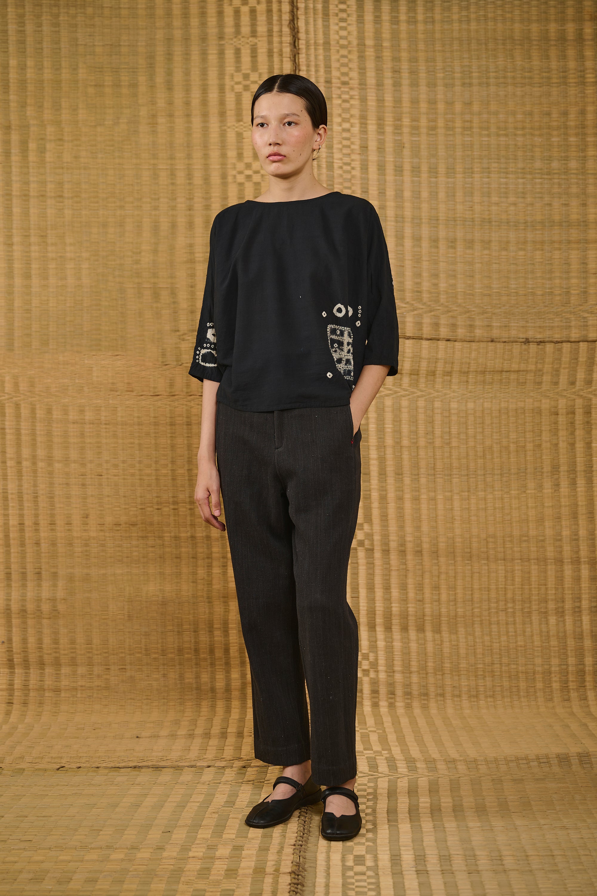 A woman wearing shibori sleeve top