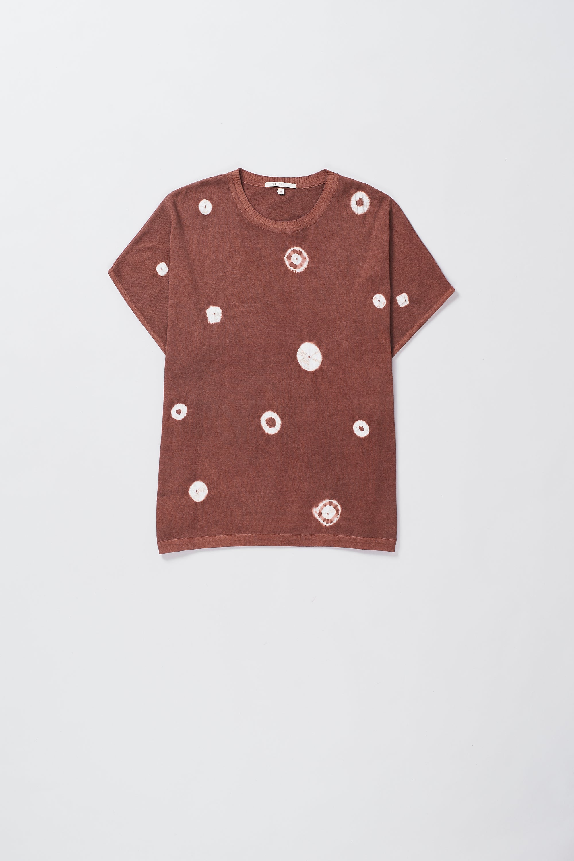 A relaxed fit t-shirt in rouge pink with distinctive half-length sleeves, displayed against a neutral background.