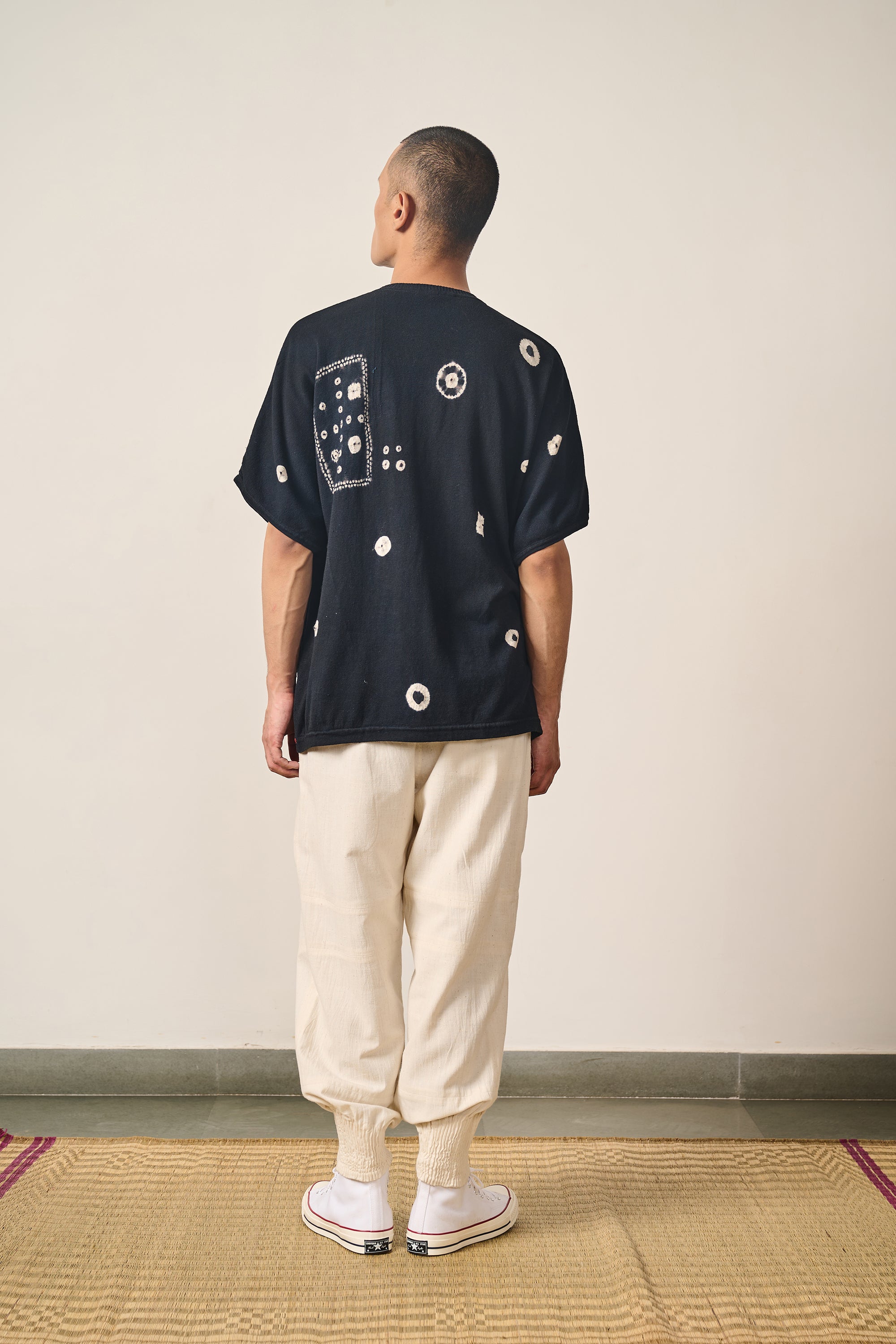 A back shot of a man wearing black cotton t-shirt