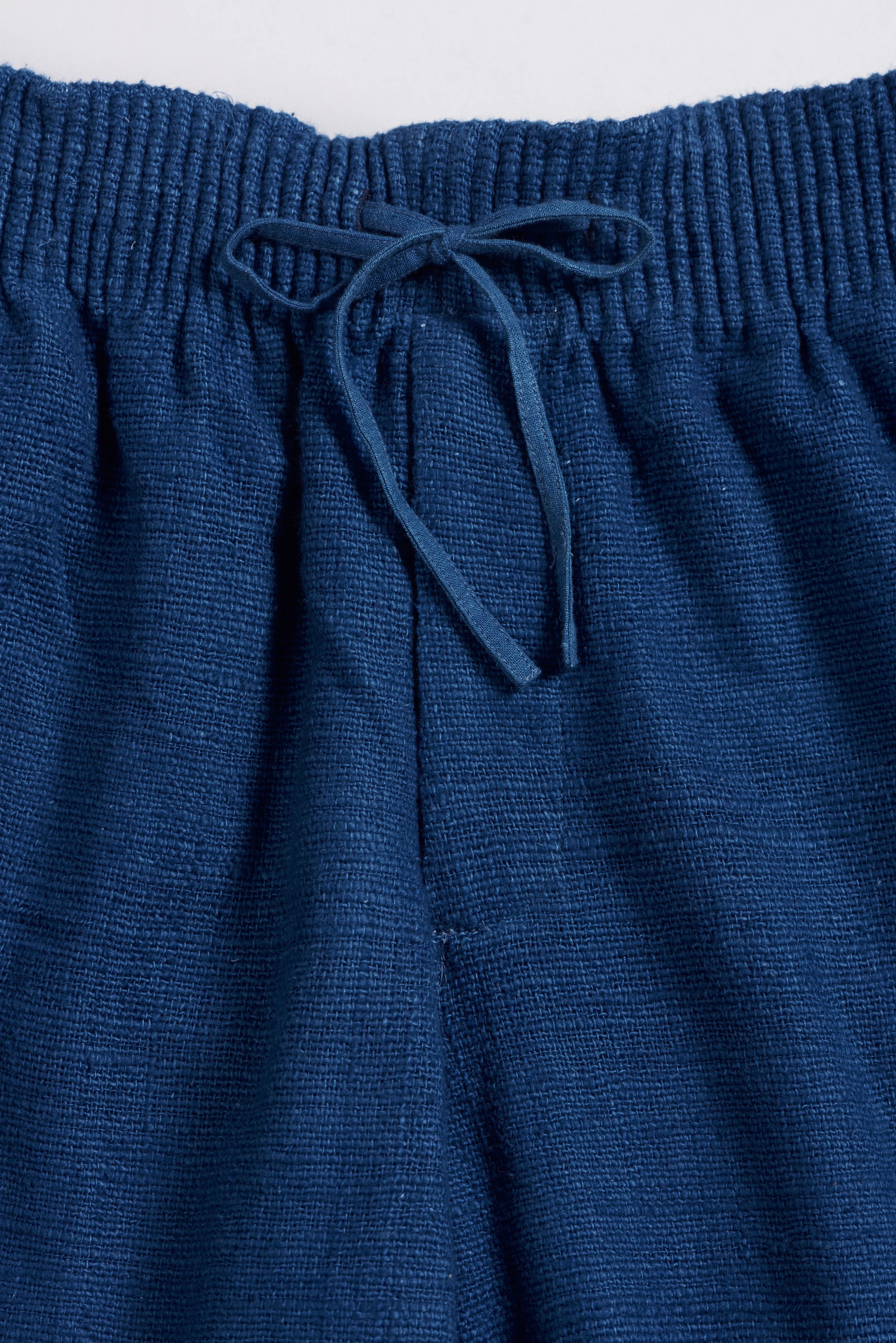 Close-up of medium indigo cotton pant
