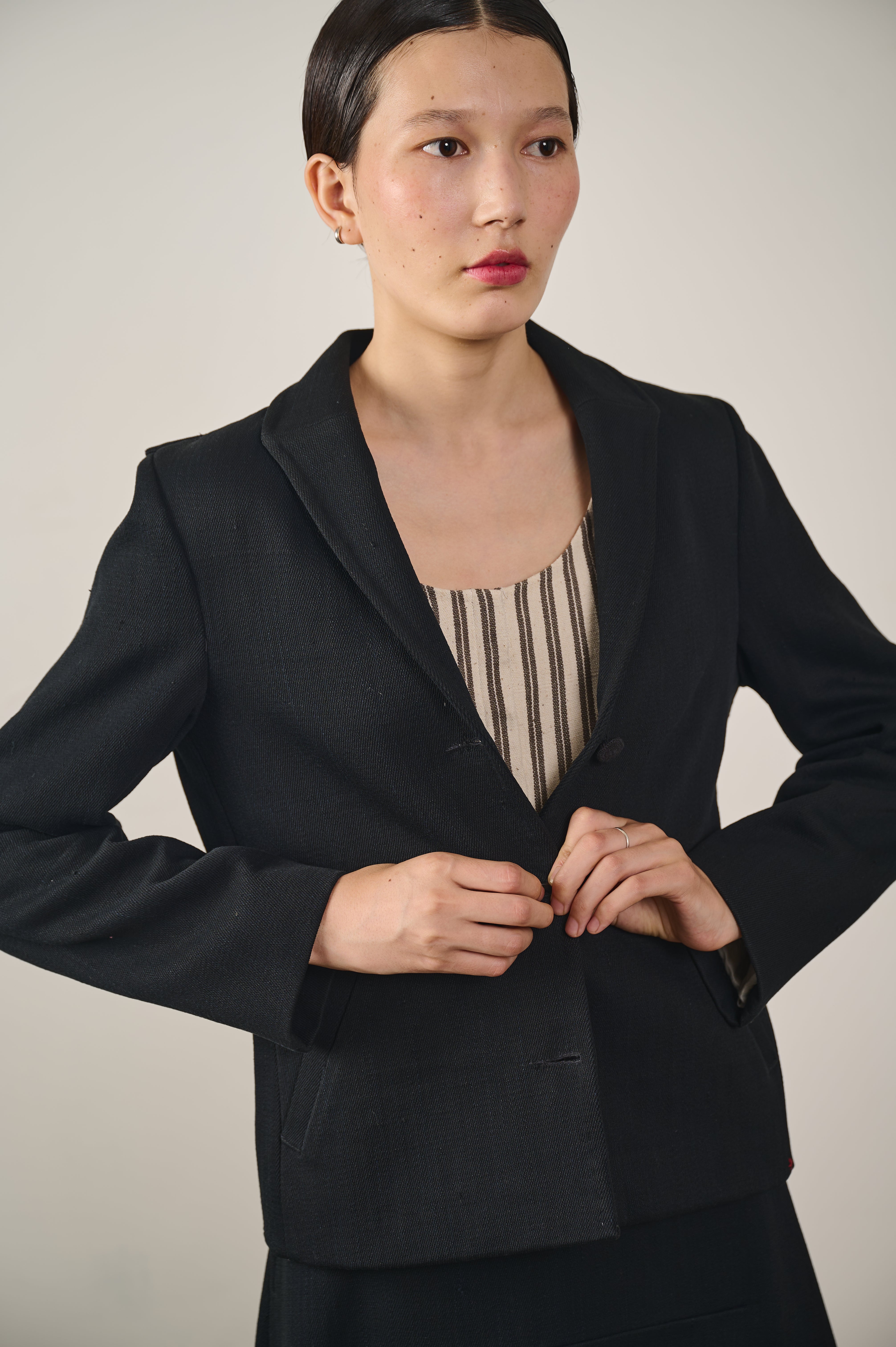 A close-up shot of a woman wearing black denim jacket