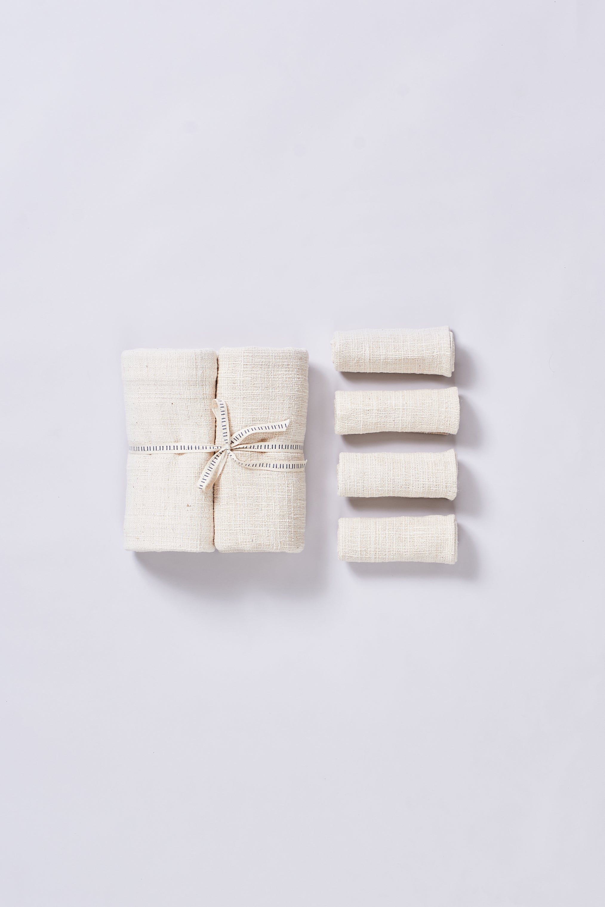 A set of five ecru towel with a white ribbon