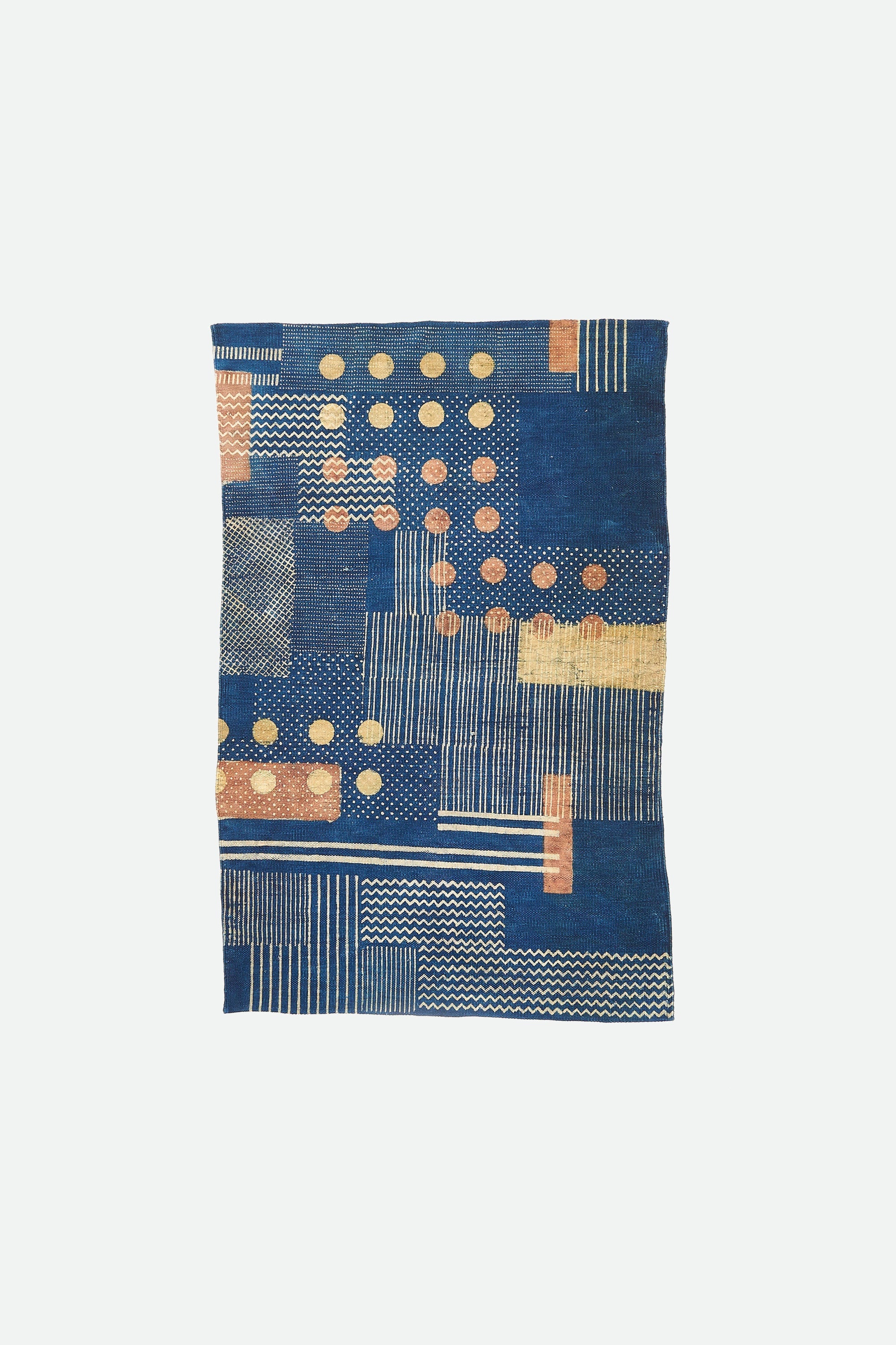 Indigo multi colour quilt on a white background