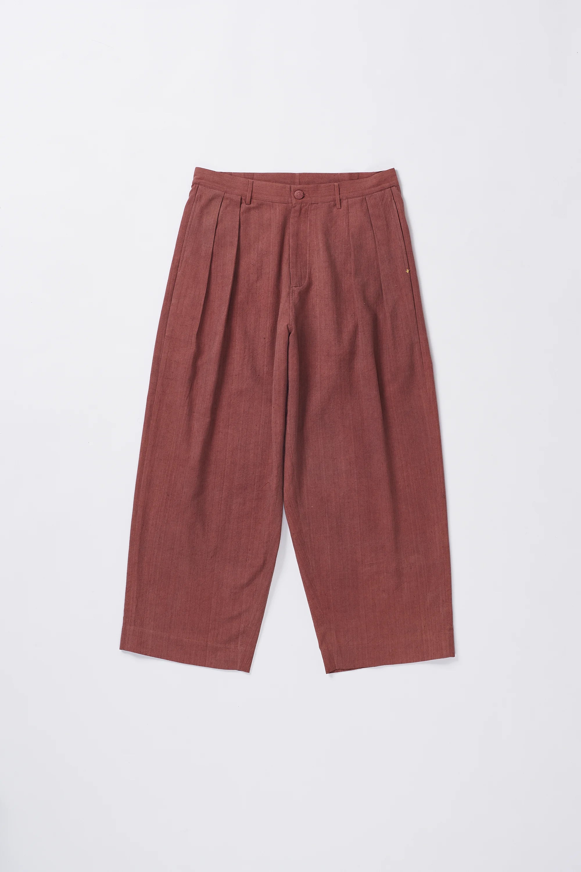 Rogue Pink pleated pants on a grey background