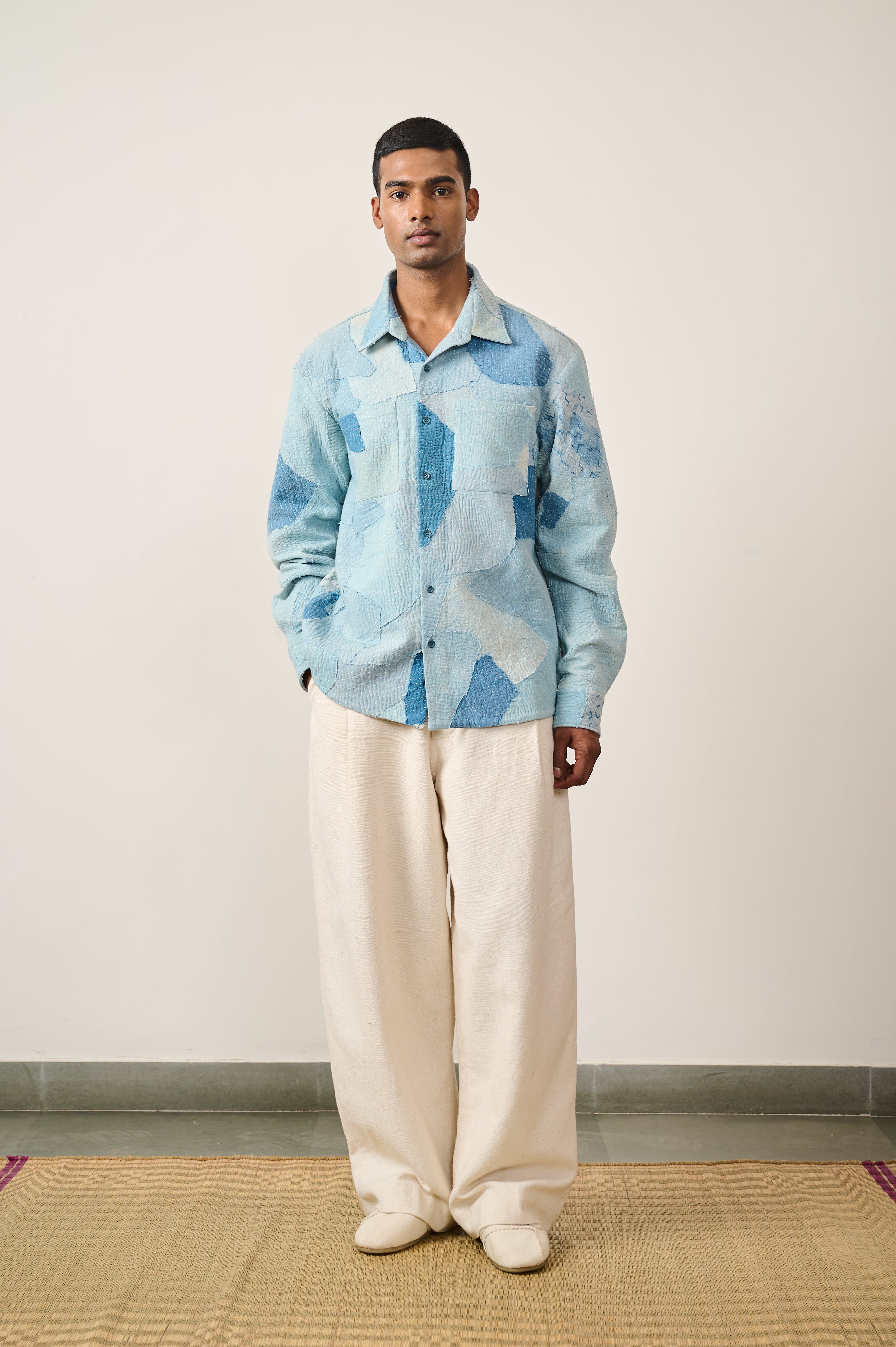 A man wearing sky indigo shirt with patchwork