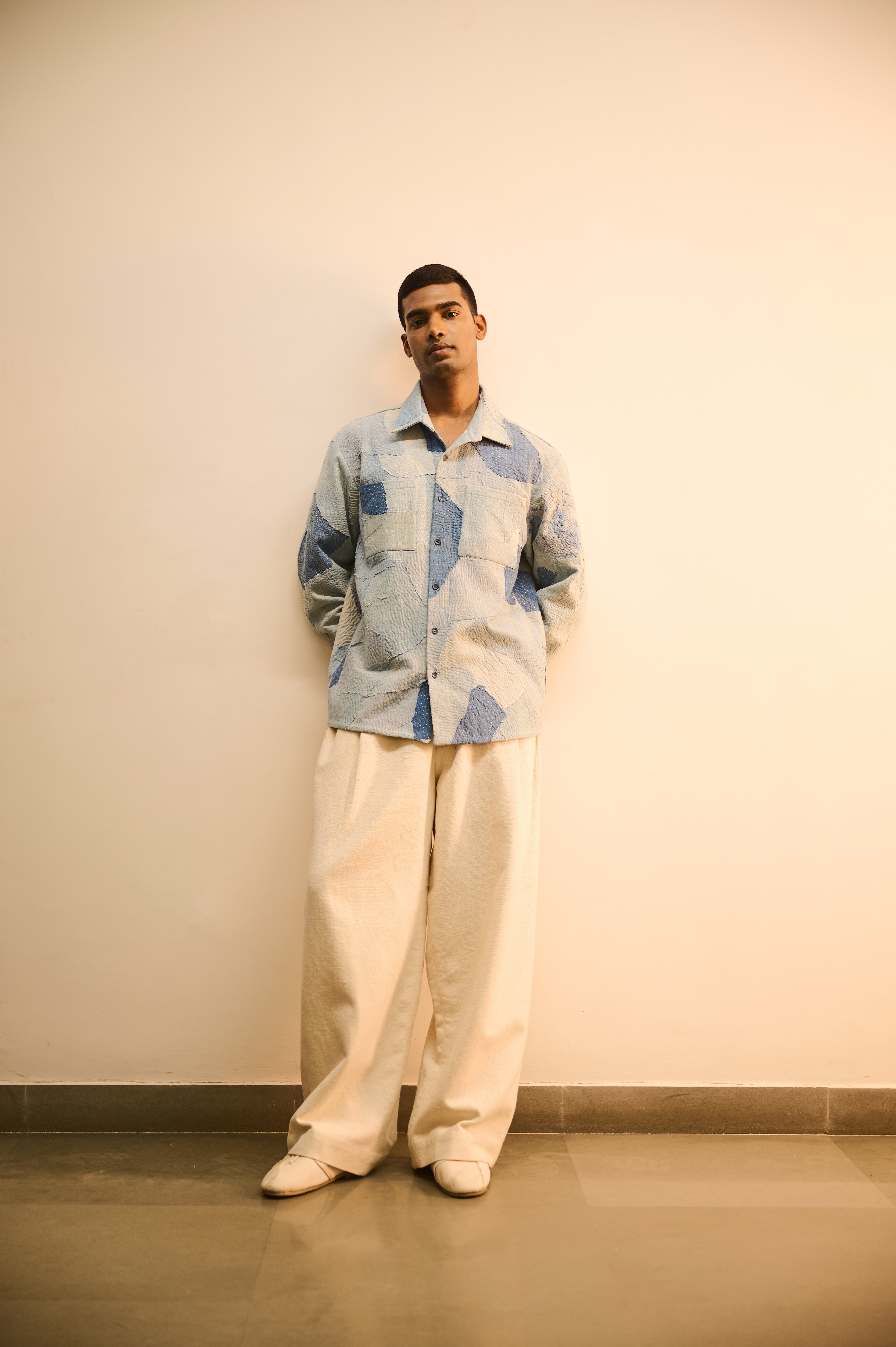 A man wearing sky indigo cotton shirt with patchwork