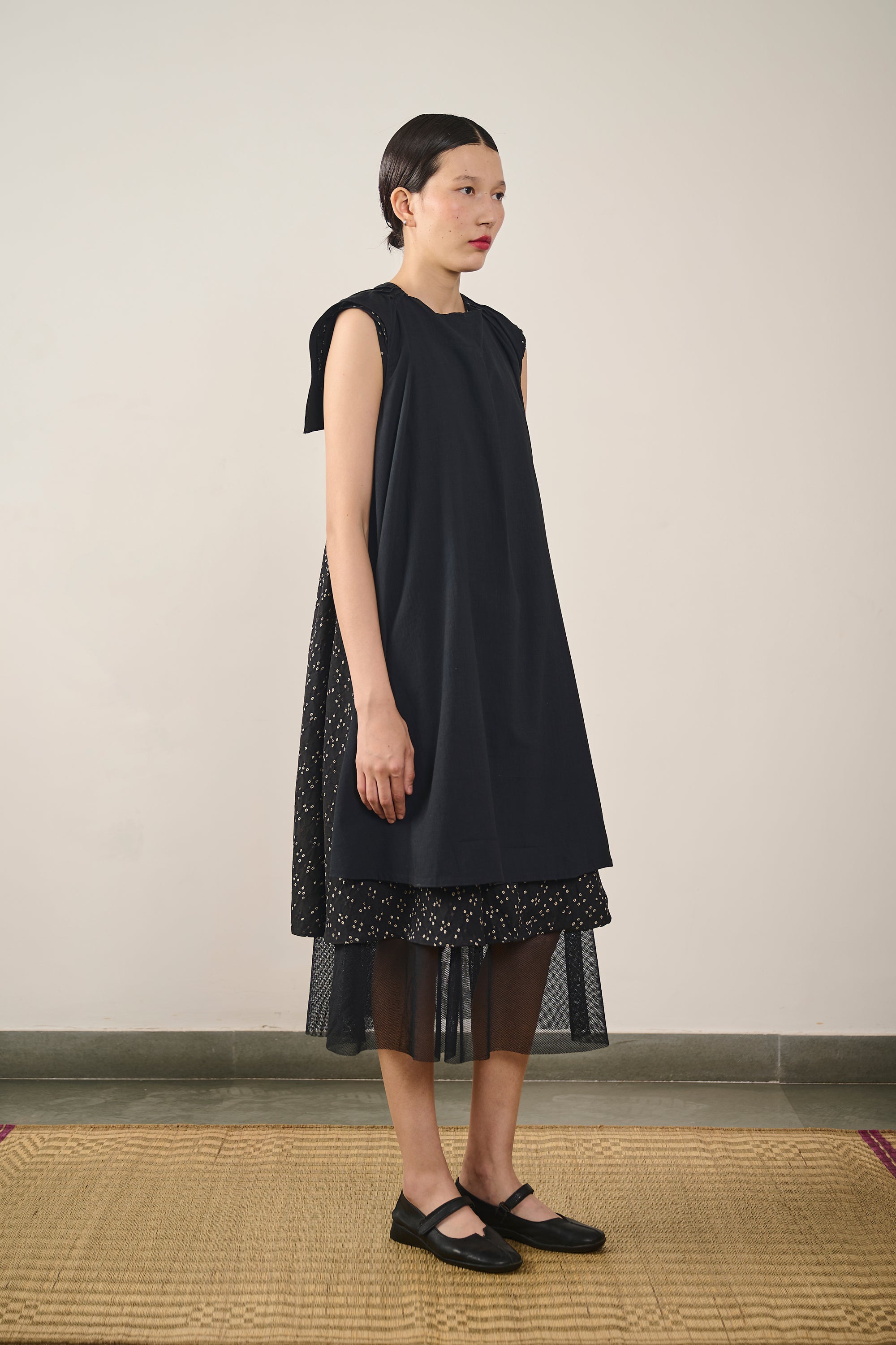A woman wearing black cotton dress