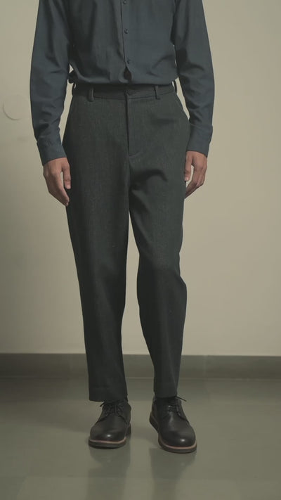 Man wearing a indigo shirt and midnight indigo pants against a Grey background