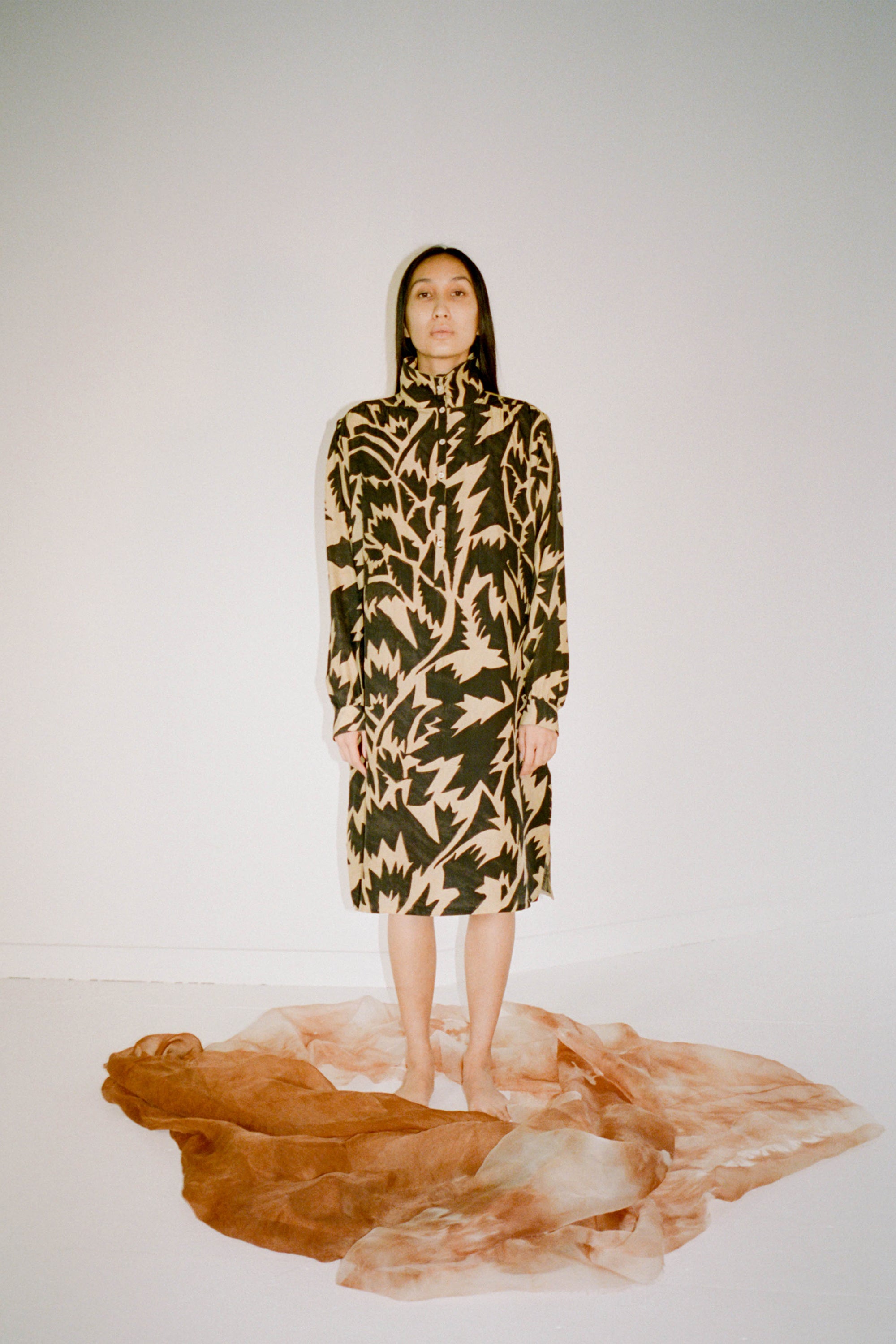 A woman wearing funnel neck silk dress