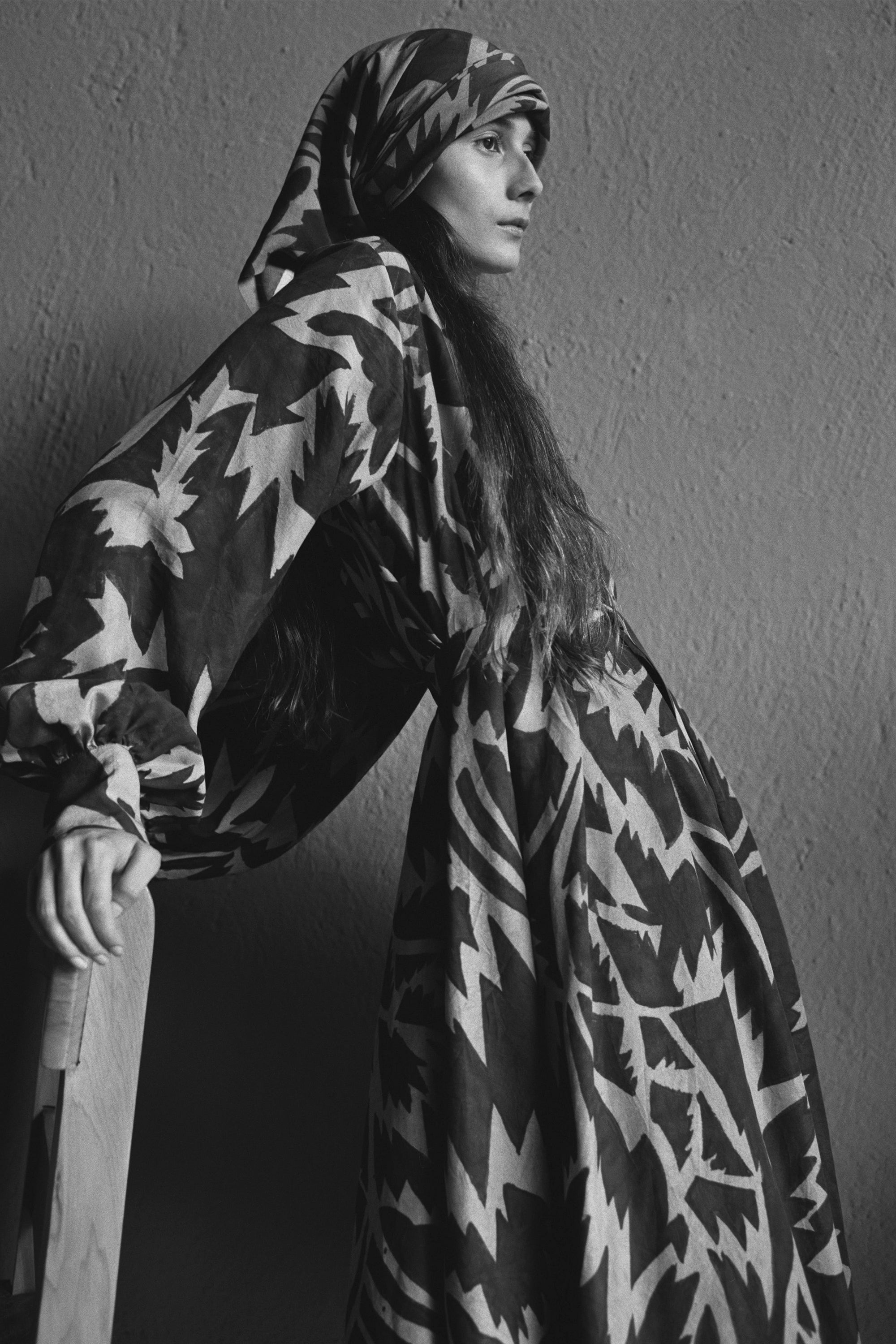A woman wearing Hand painted dress on a grey background